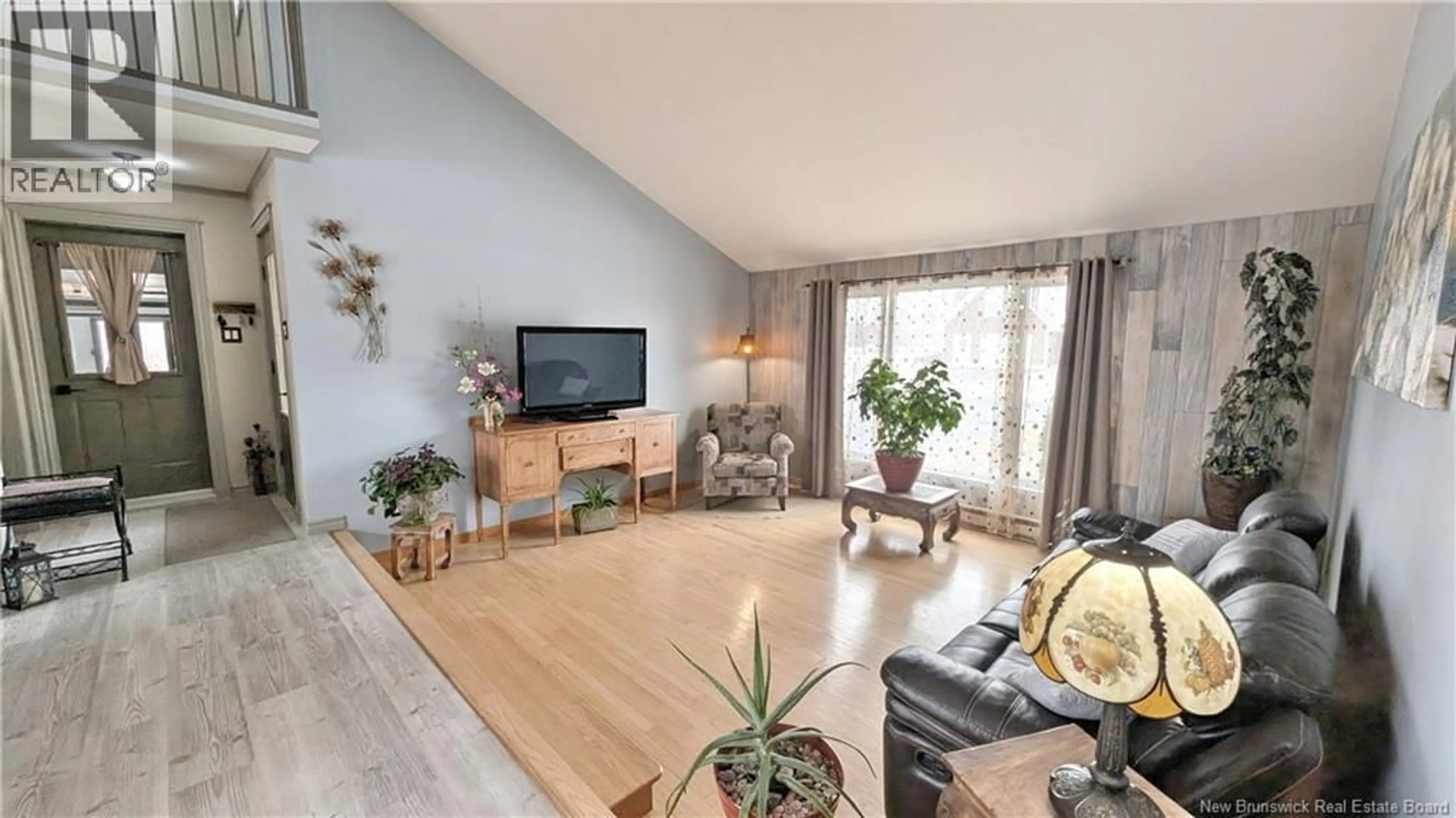 Living room with furniture, wood/laminate floor for 27 RUE DU BICENTENAIRE, Caraquet New Brunswick E1W1A3