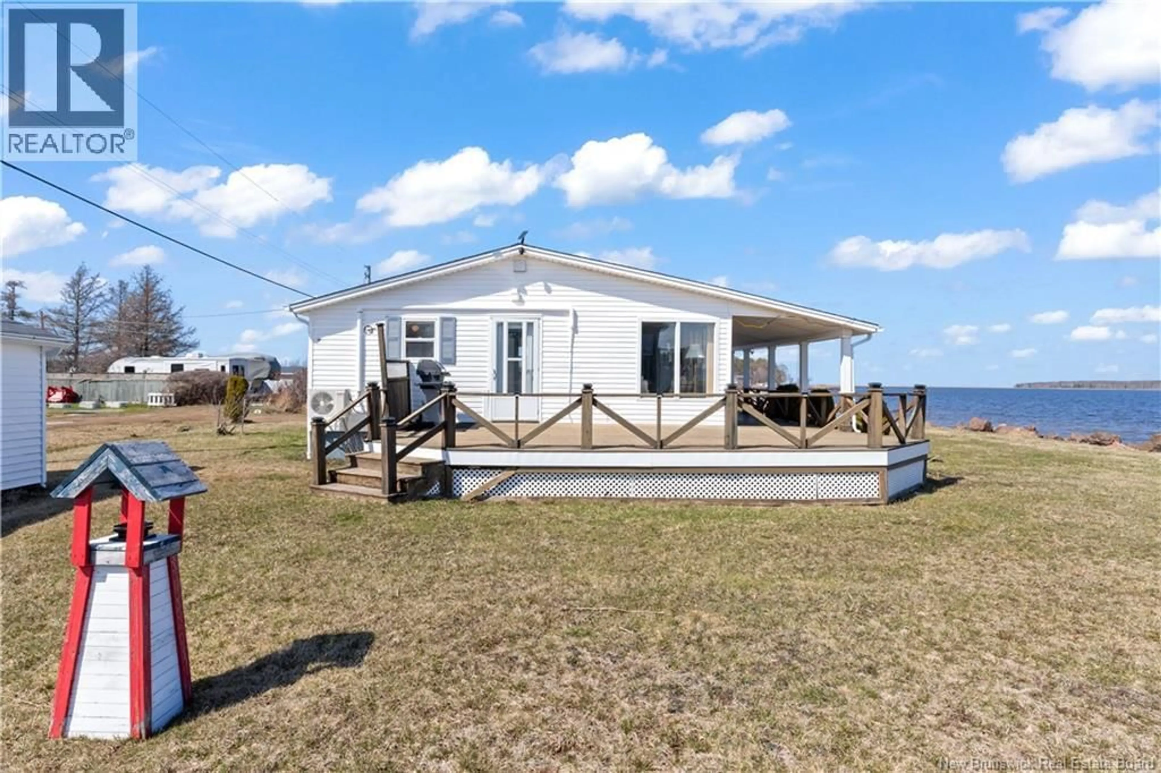 A pic from outside/outdoor area/front of a property/back of a property/a pic from drone, water/lake/river/ocean view for 64 DE LA MER, Cocagne New Brunswick E4R2M1