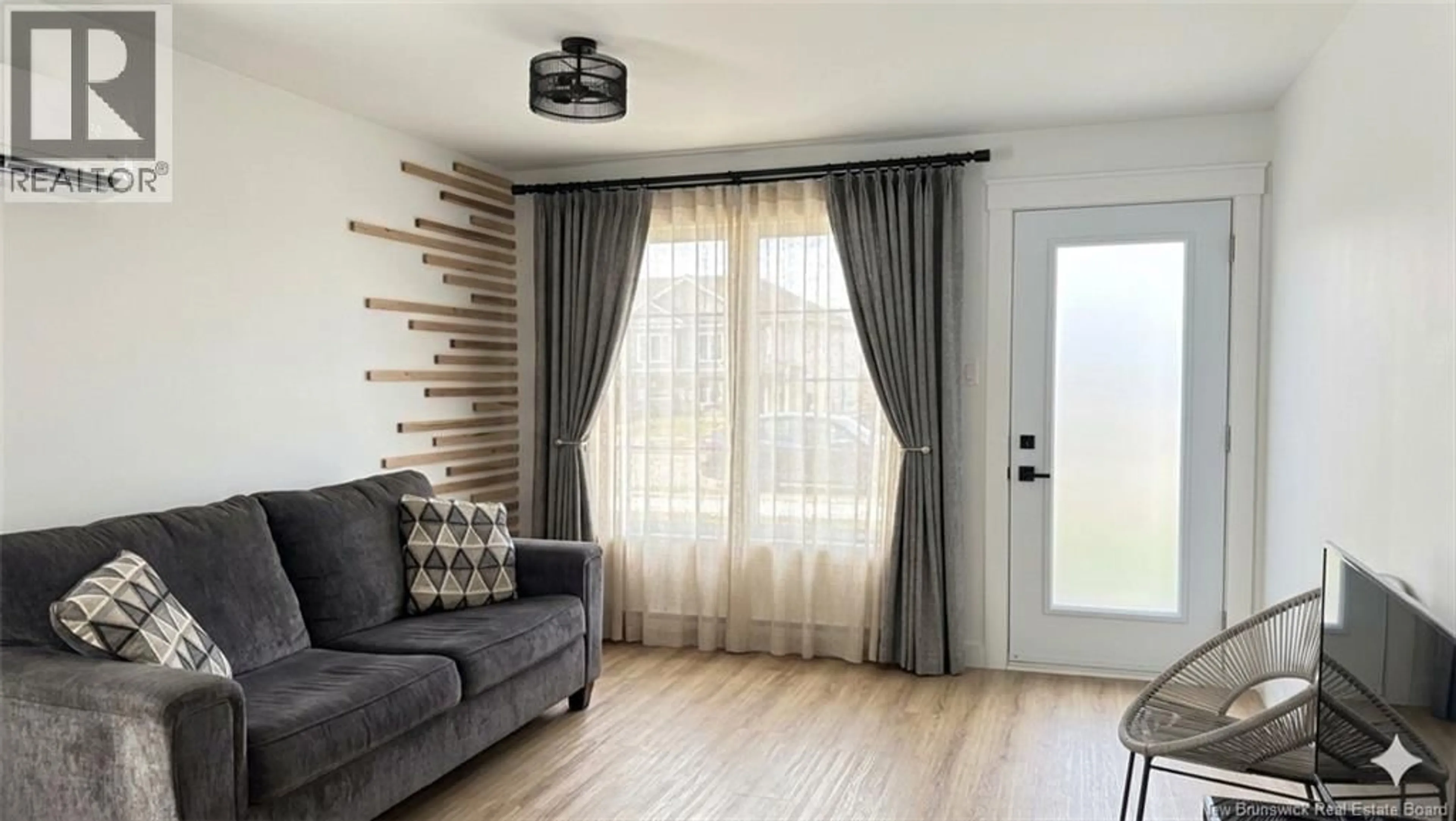 Living room with furniture, wood/laminate floor for 22 COLTER STREET, Saint John New Brunswick E2J3B2