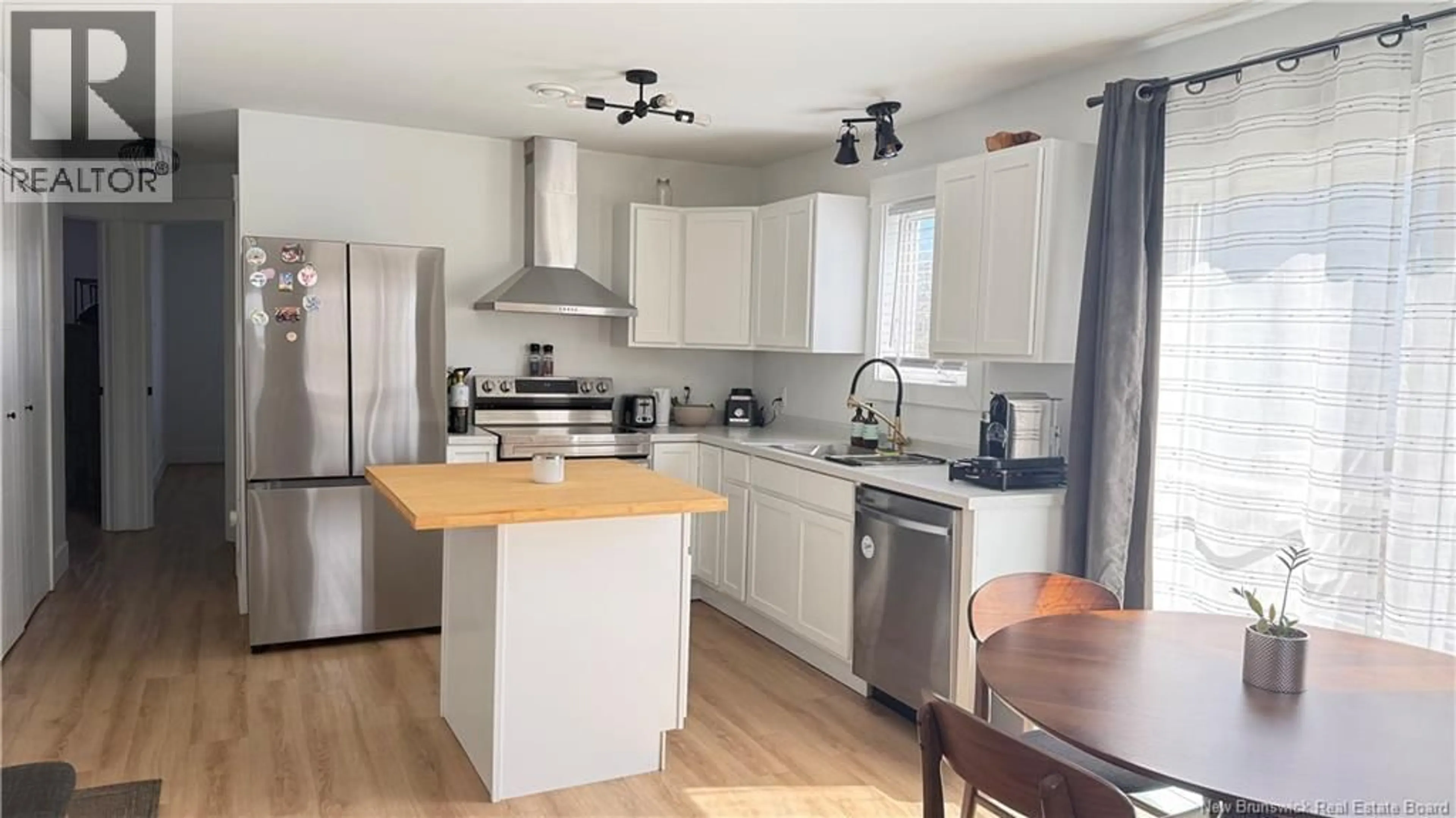 Open concept kitchen, wood/laminate floor for 22 COLTER STREET, Saint John New Brunswick E2J3B2