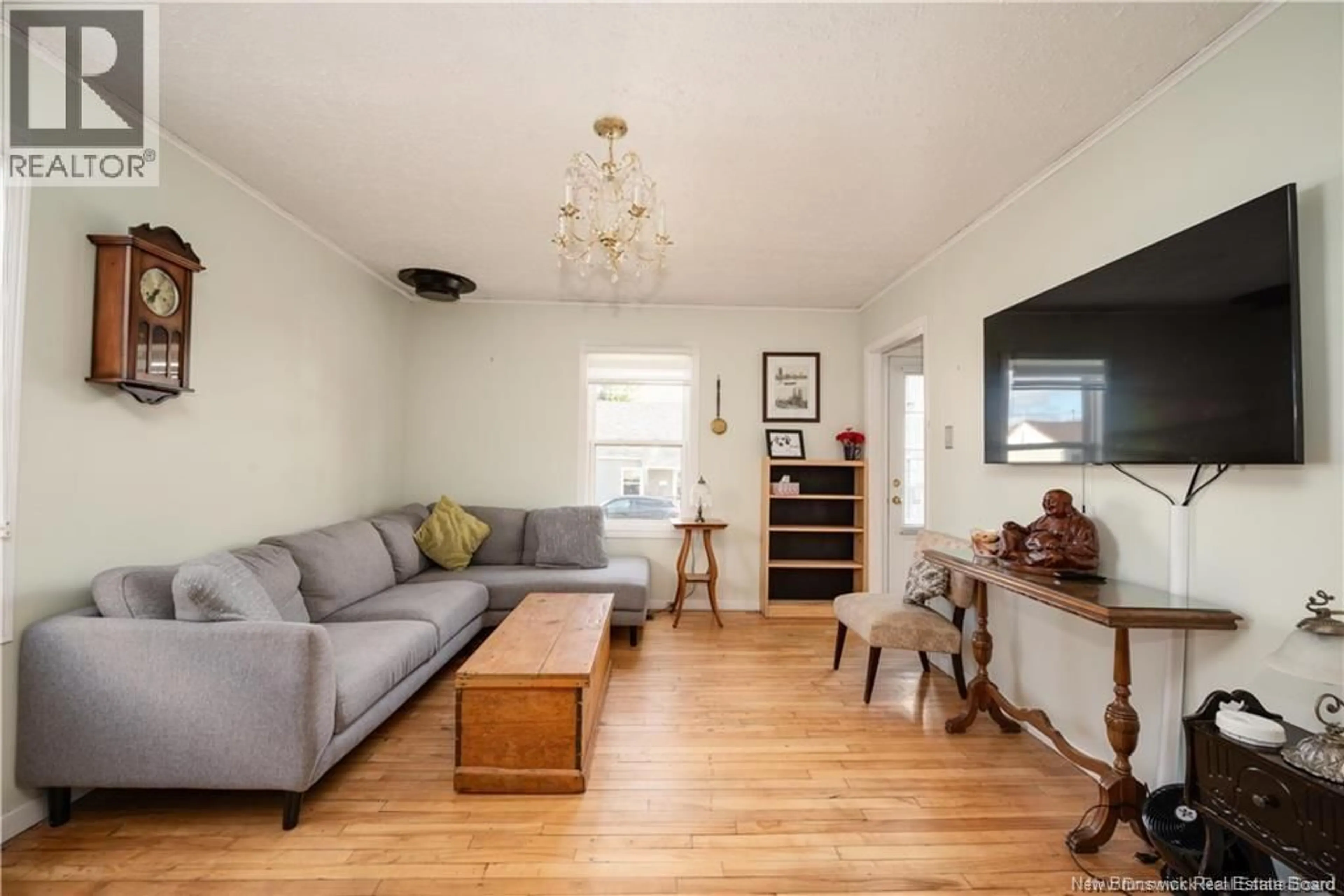 Living room with furniture, wood/laminate floor for 29 COPP STREET, Dieppe New Brunswick E1A2G9