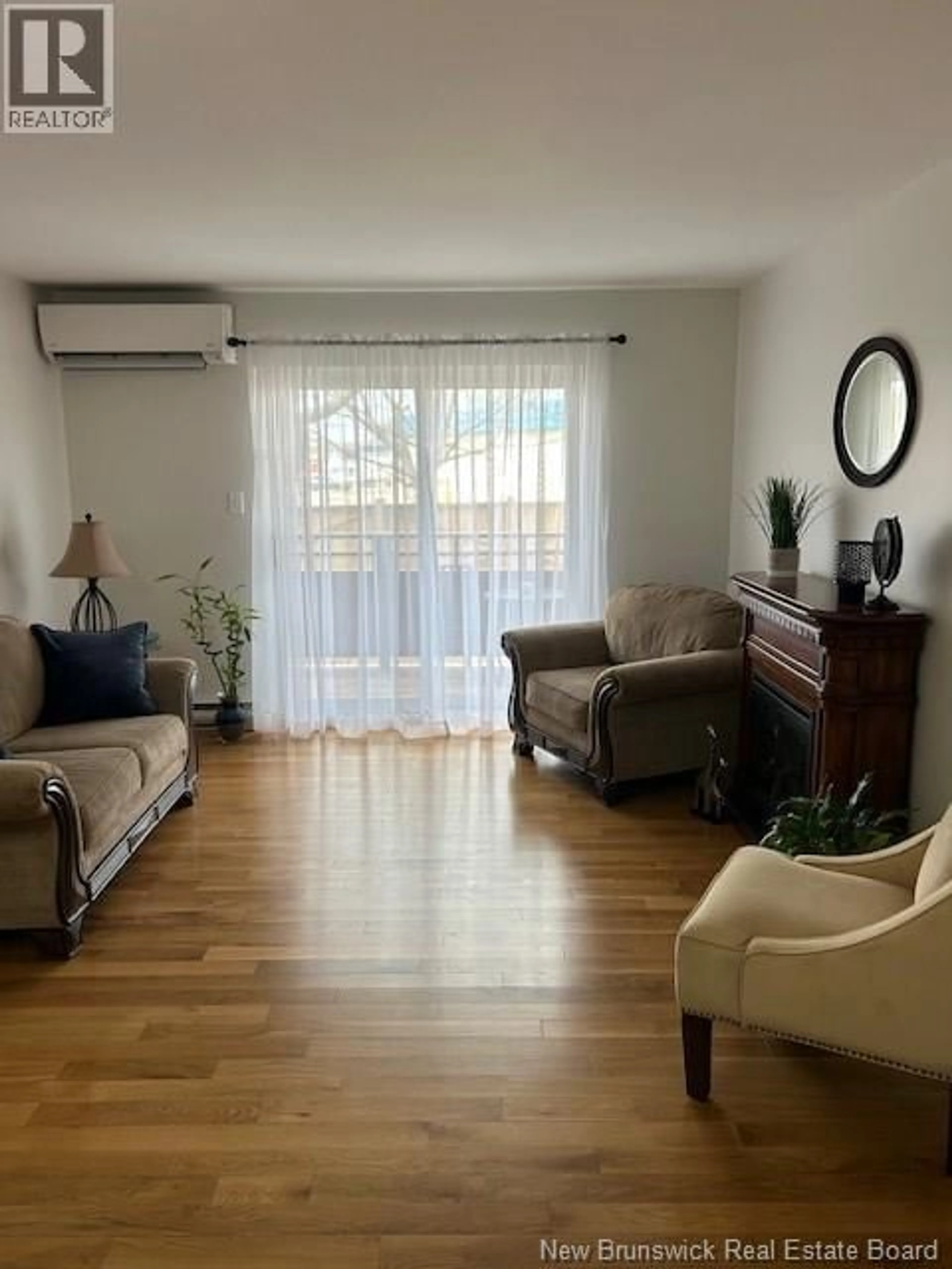 Living room with furniture, wood/laminate floor for 3 - 33 MACALEESE LANE, Moncton New Brunswick E1A3M1
