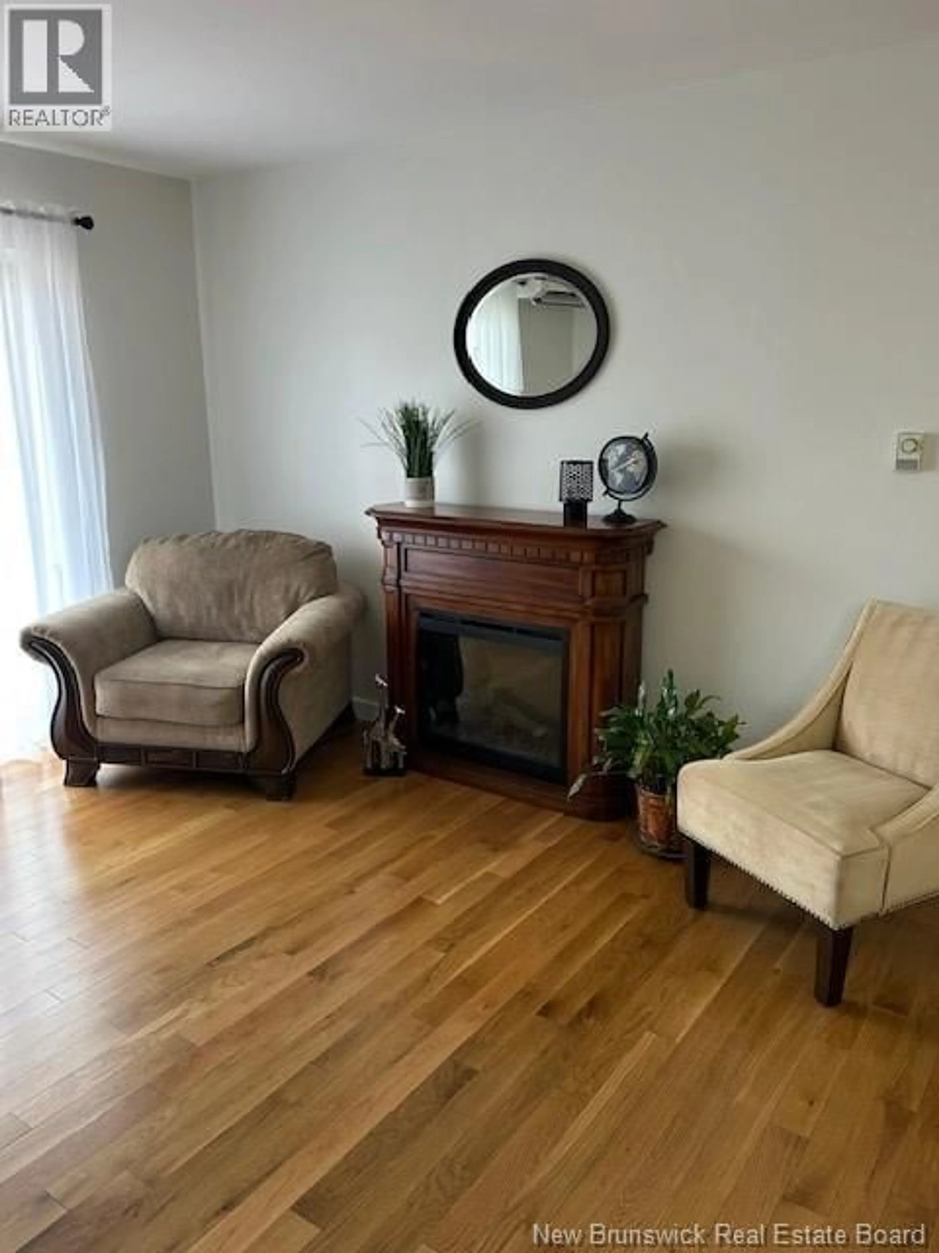 Living room with furniture, wood/laminate floor for 3 - 33 MACALEESE LANE, Moncton New Brunswick E1A3M1