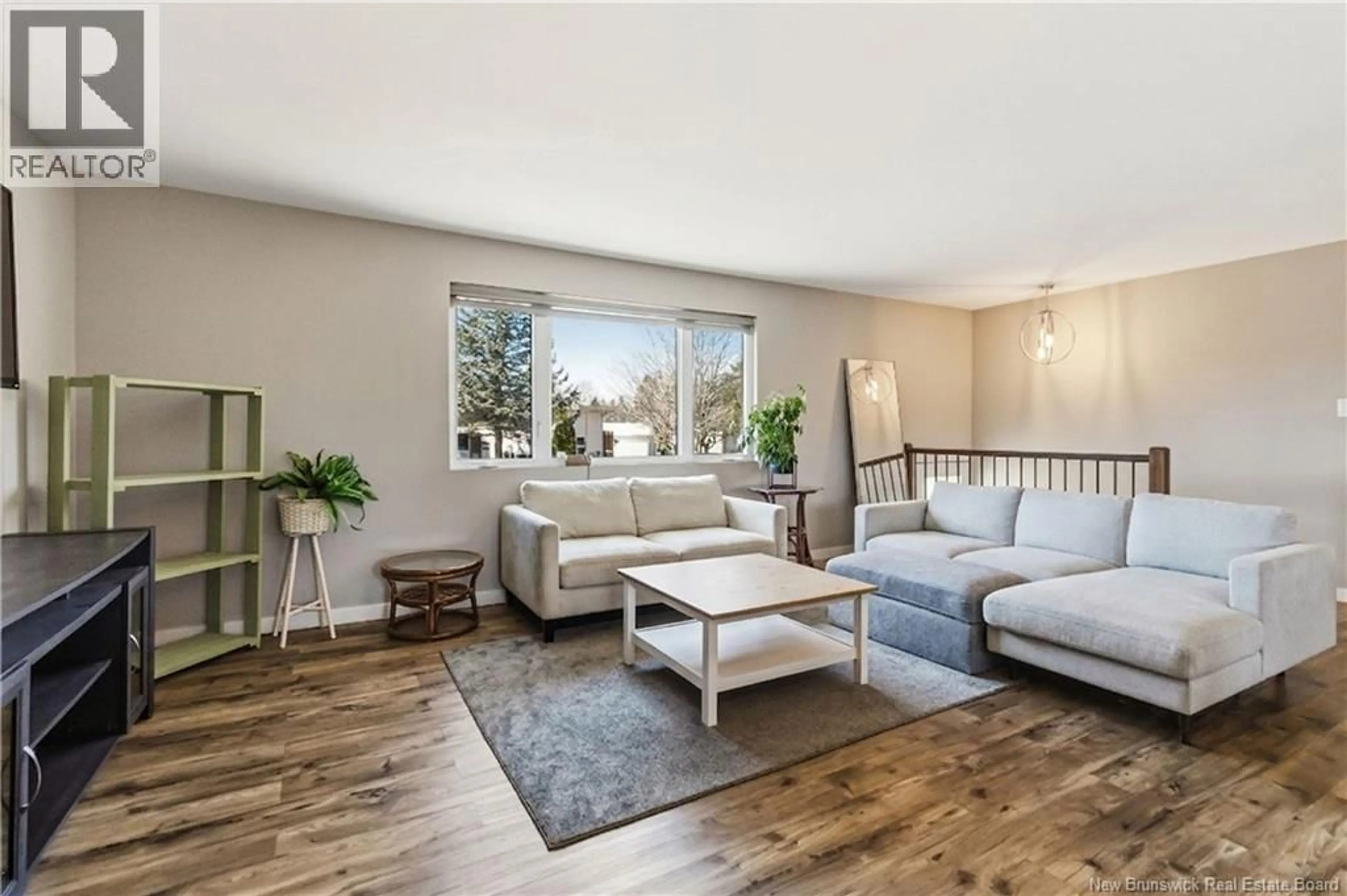 Living room with furniture, wood/laminate floor for 141-145 MCKAY AVENUE, Moncton New Brunswick E1A3A2
