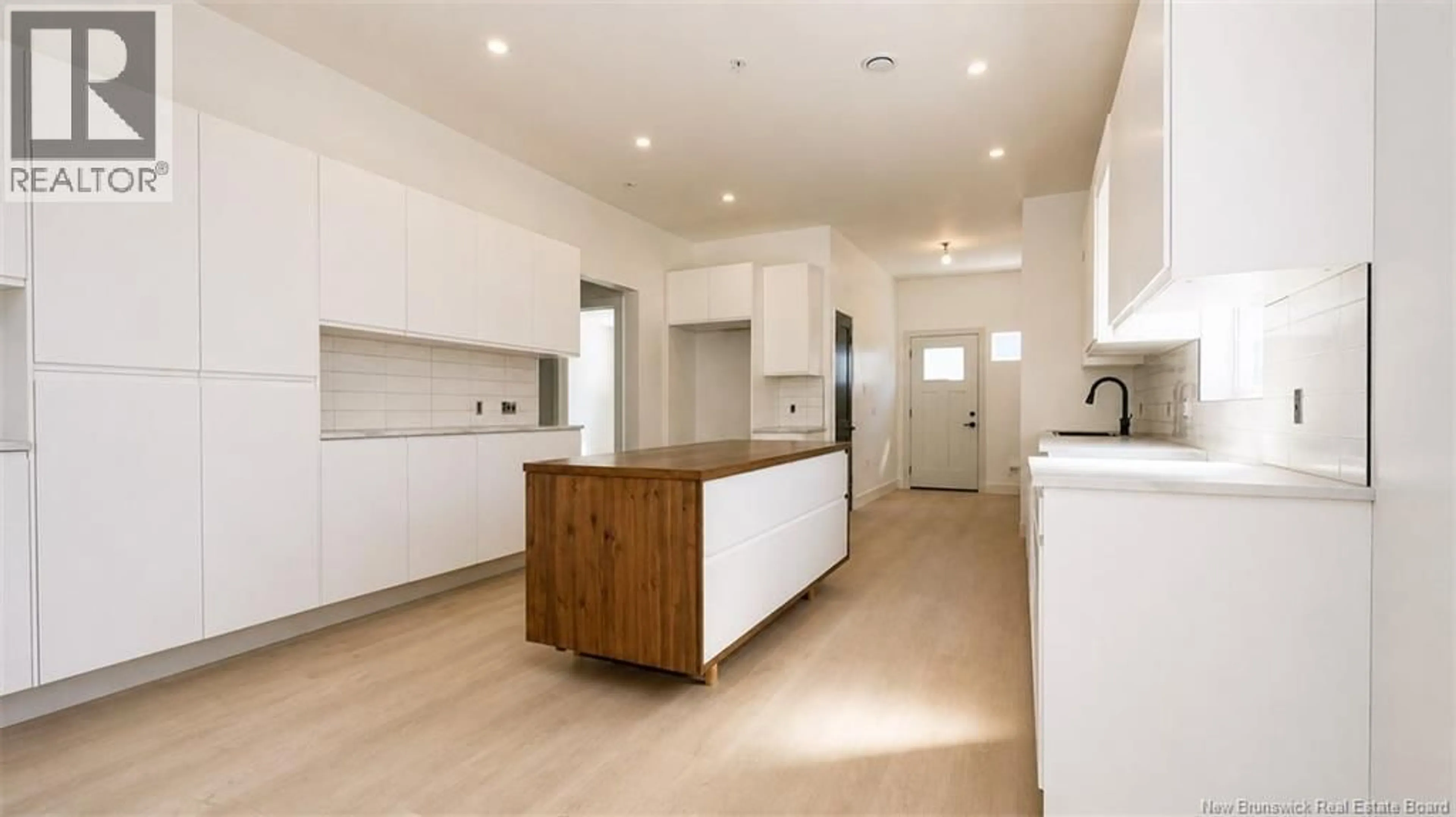 Open concept kitchen, wood/laminate floor for 18 EATON STREET, Milltown New Brunswick E3L1E7