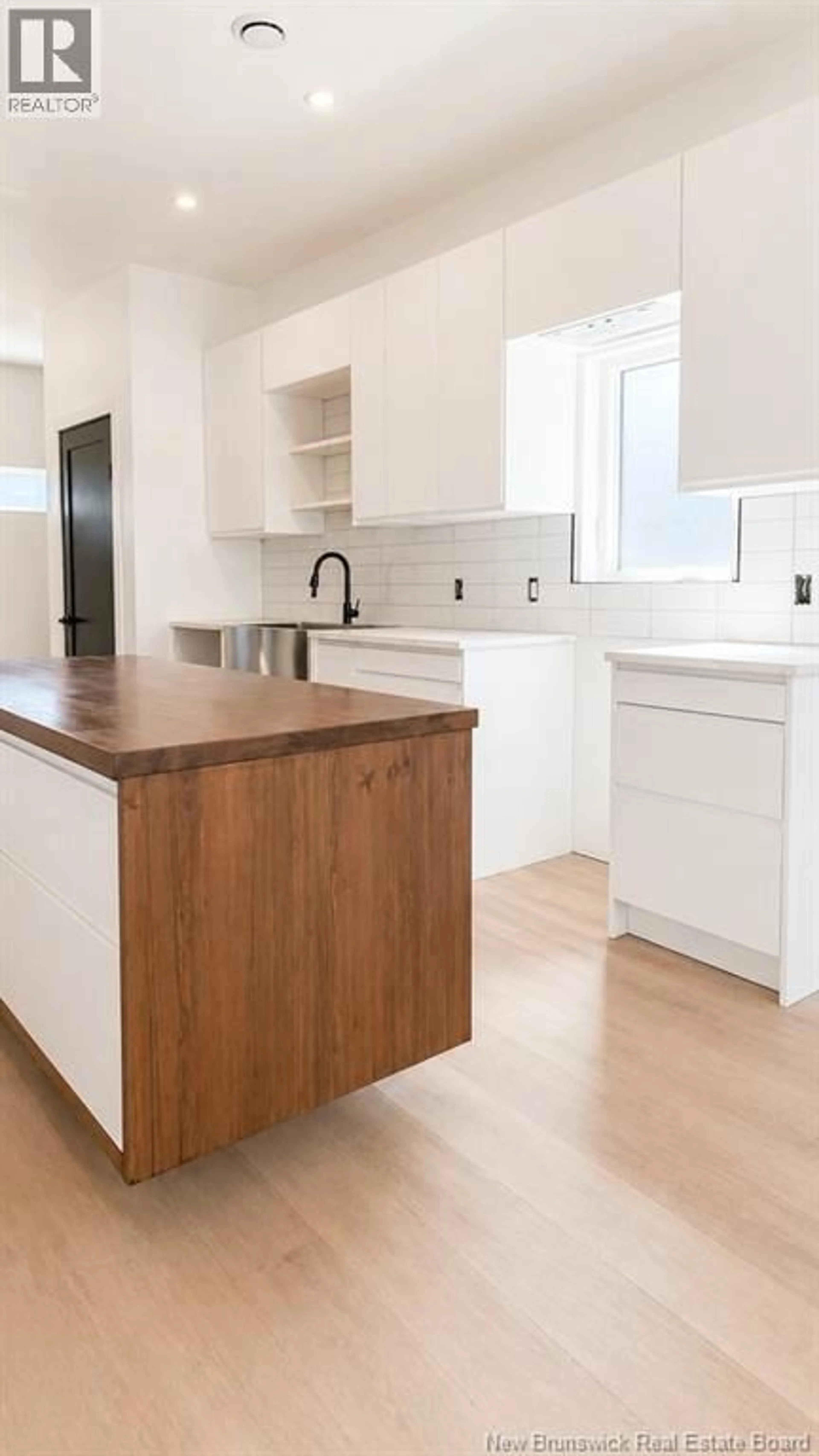 Open concept kitchen, wood/laminate floor for 18 EATON STREET, Milltown New Brunswick E3L1E7