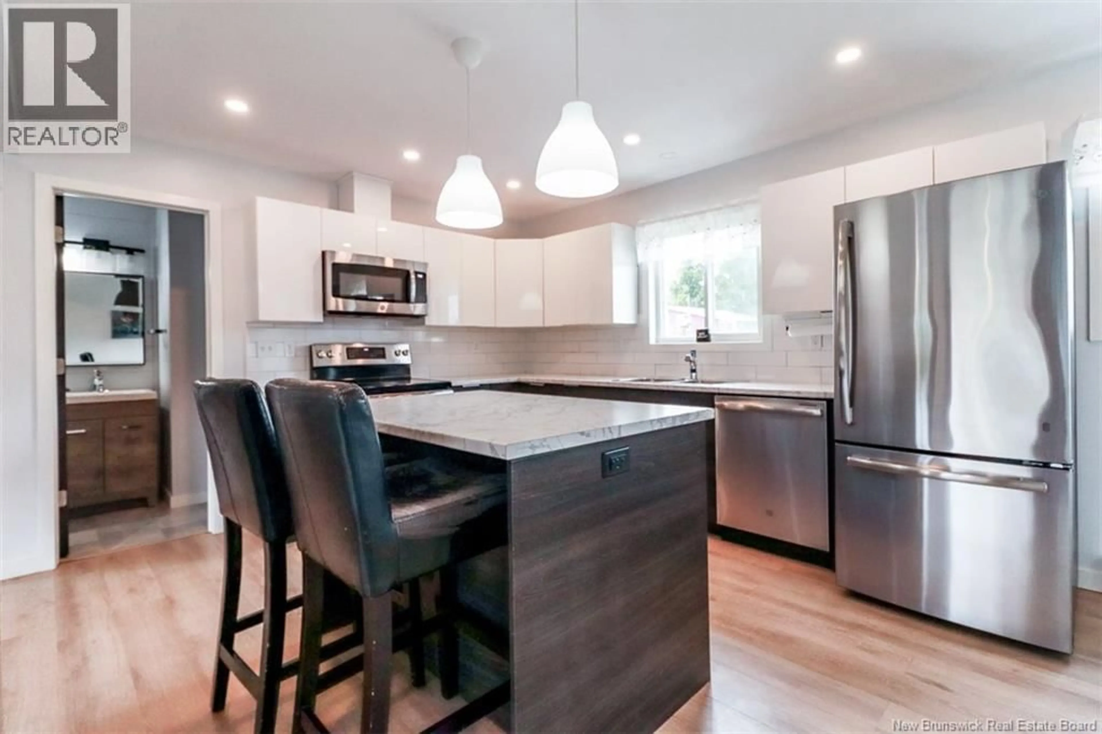 Open concept kitchen, wood/laminate floor for 70 GLEN ROAD, Saint John New Brunswick E2H2E1
