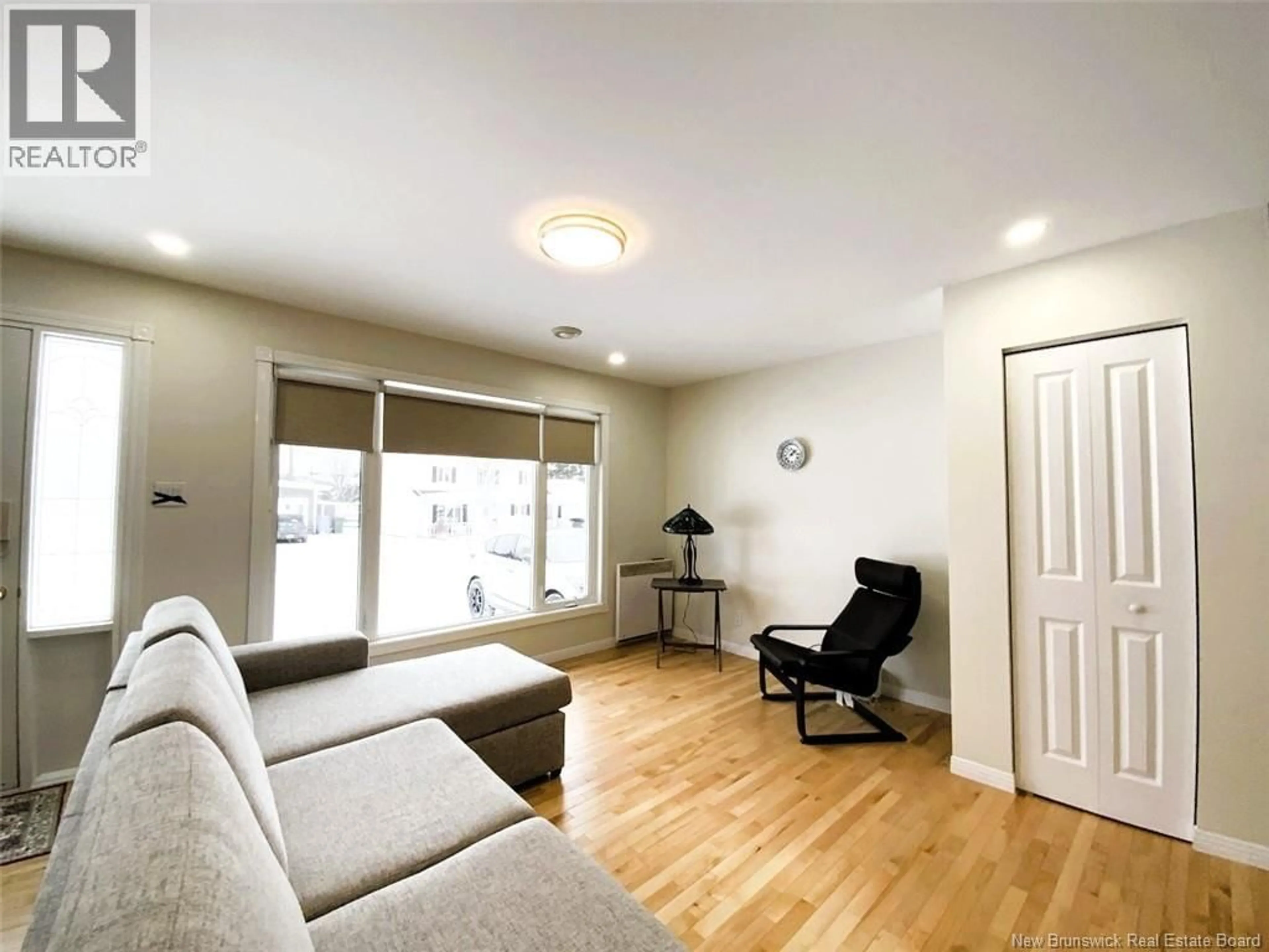 Living room with furniture, wood/laminate floor for 64 CHOUINARD AVENUE, Edmundston New Brunswick E3V3L8