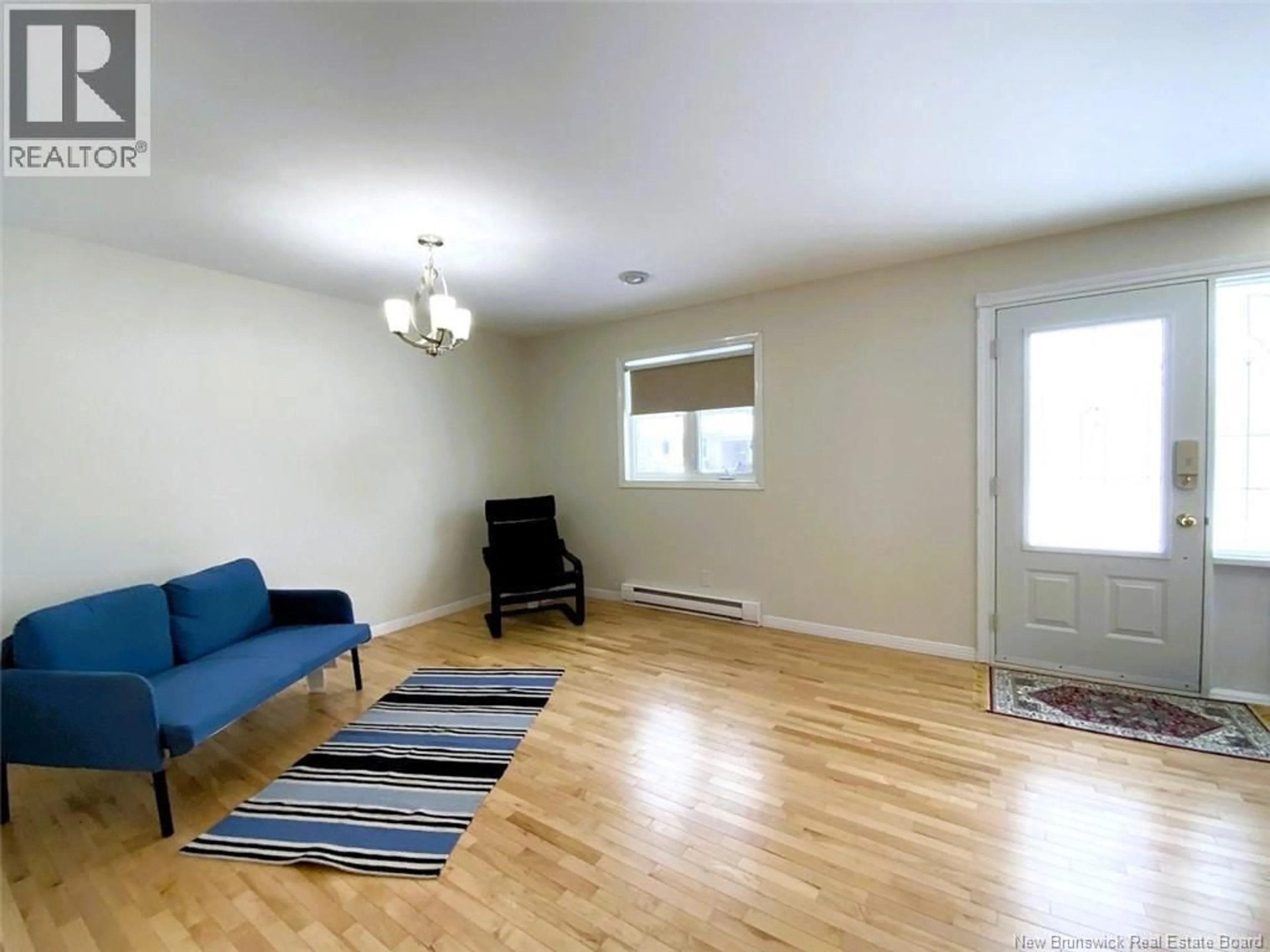 Living room with furniture, wood/laminate floor for 64 CHOUINARD AVENUE, Edmundston New Brunswick E3V3L8