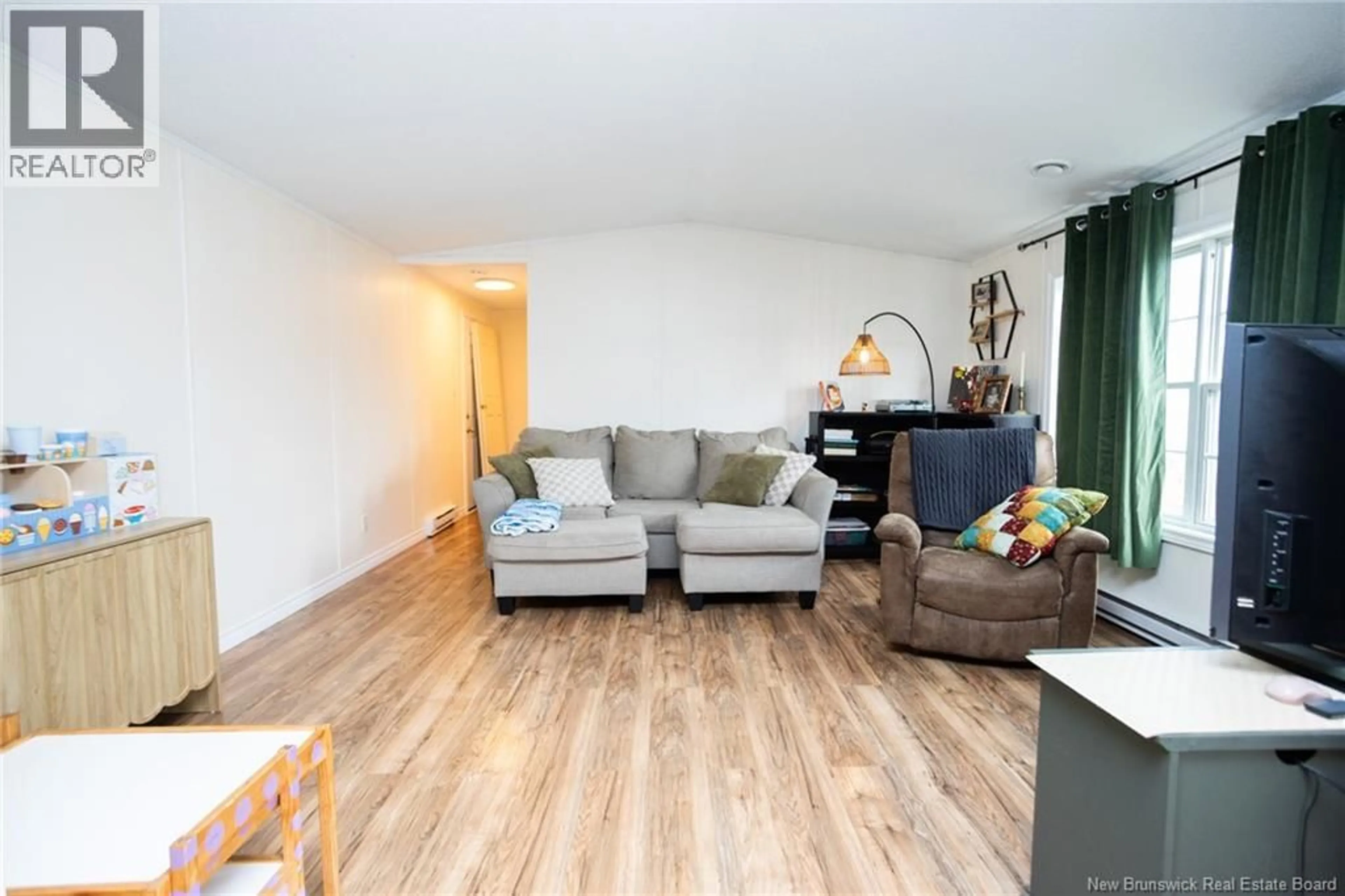 Living room with furniture, wood/laminate floor for 100 DOUGNORTH STREET, Fredericton New Brunswick E3G0X2