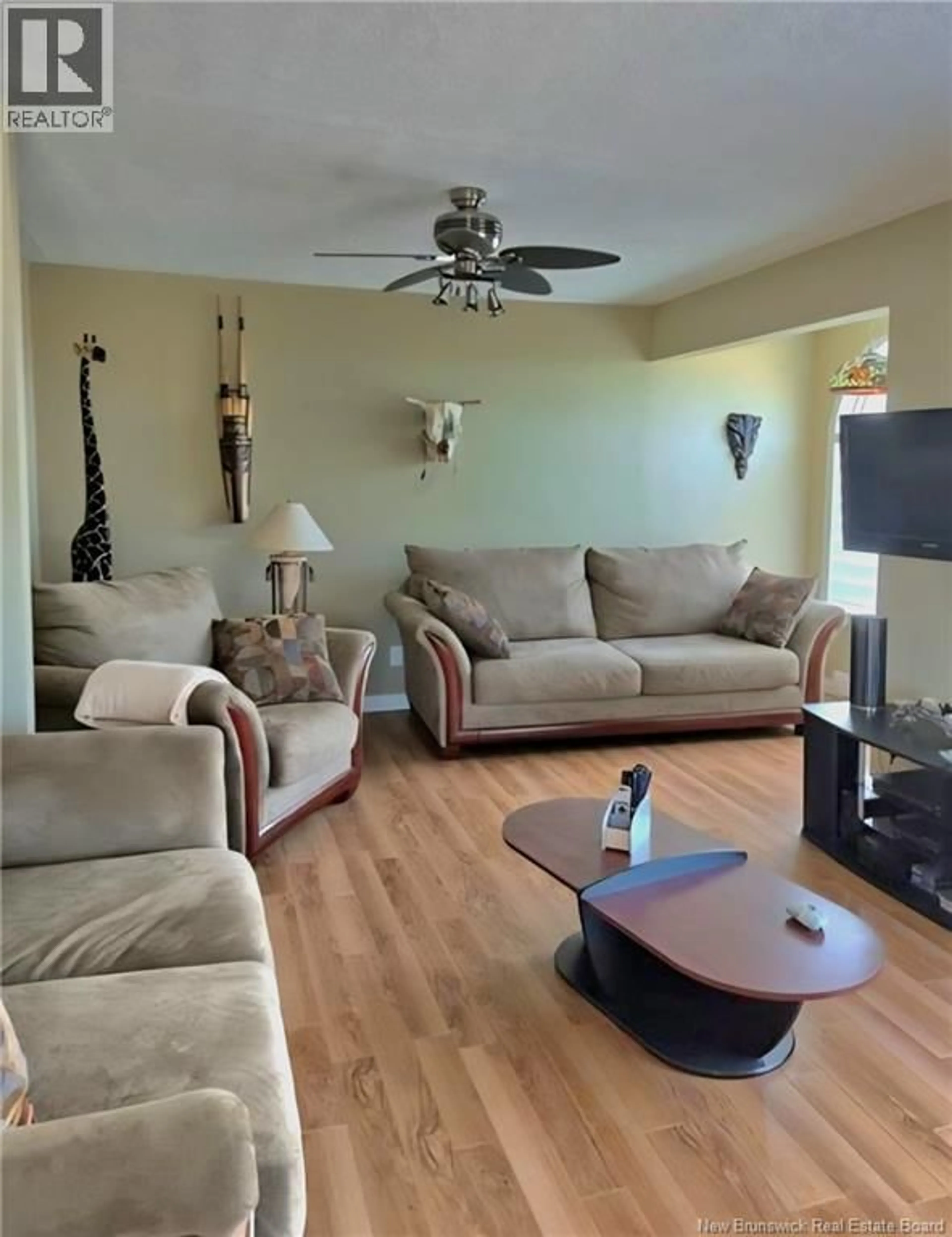 Living room with furniture, wood/laminate floor for 181 CHEMIN WARD, Miscou New Brunswick E8T2G5