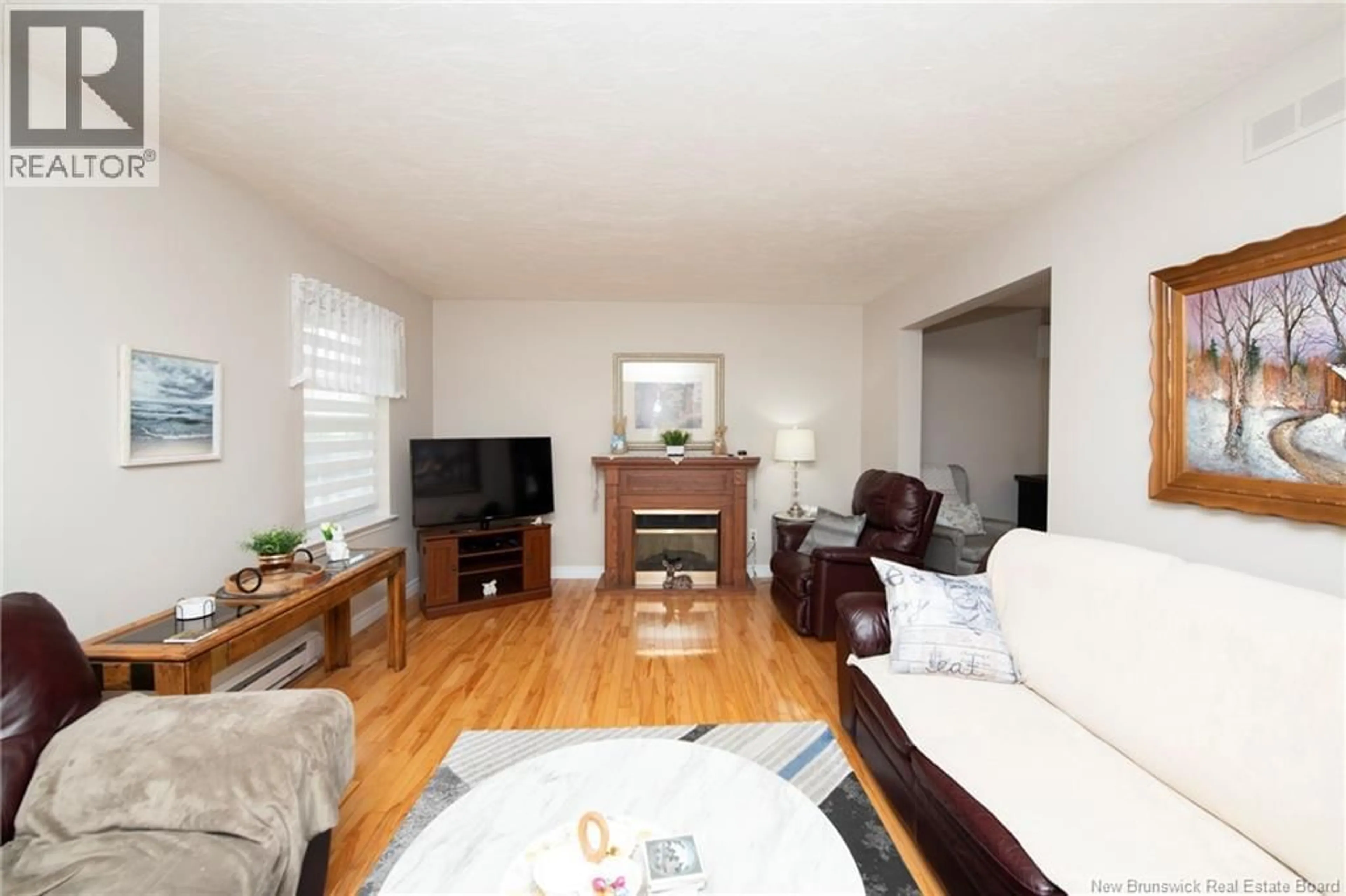 Living room with furniture, wood/laminate floor for 313 WORTHINGTON AVENUE, Moncton New Brunswick E1C0B7