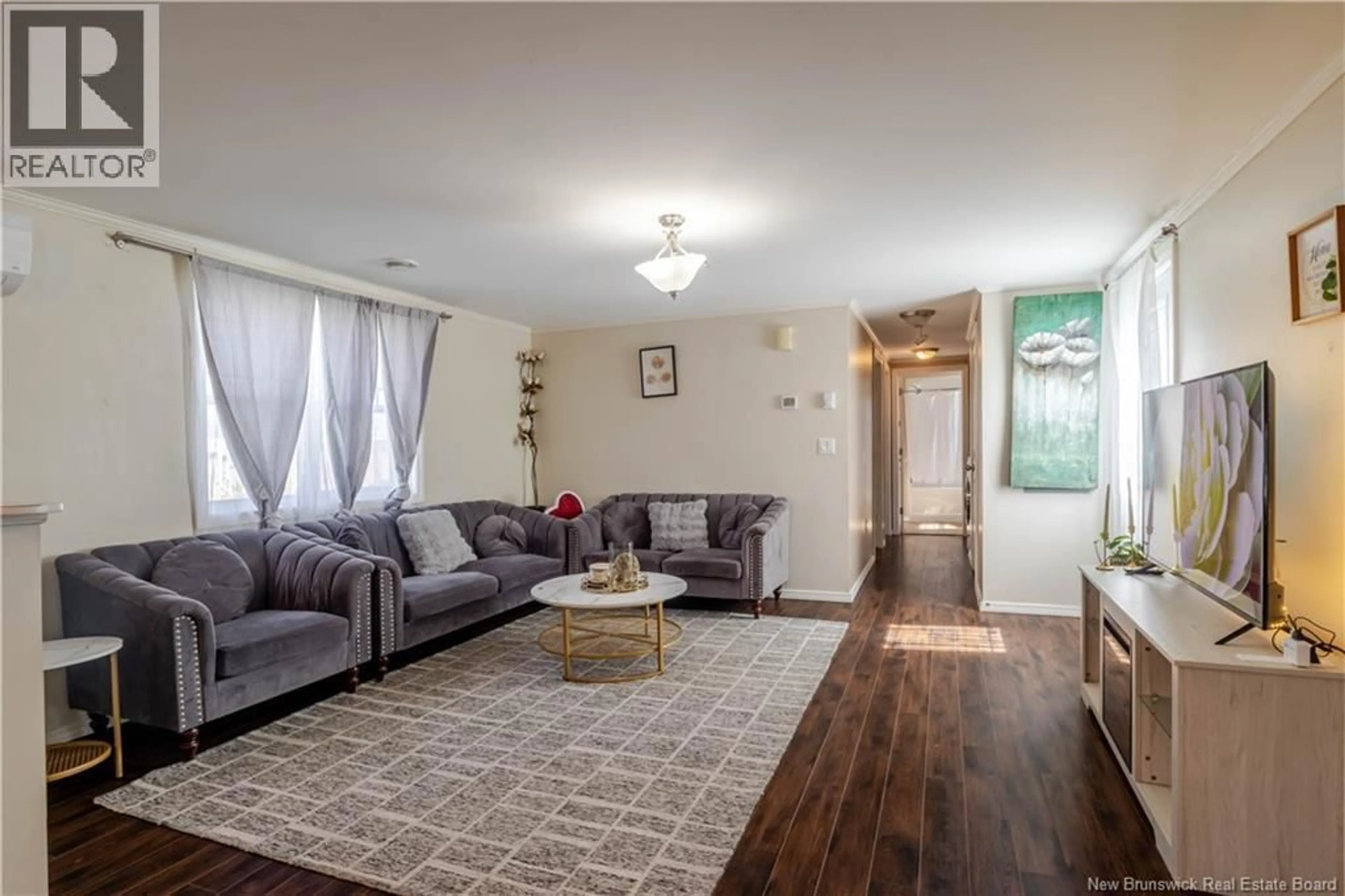Living room with furniture, wood/laminate floor for 154 CASSIDY CIRCLE, Fredericton New Brunswick E3B7N3