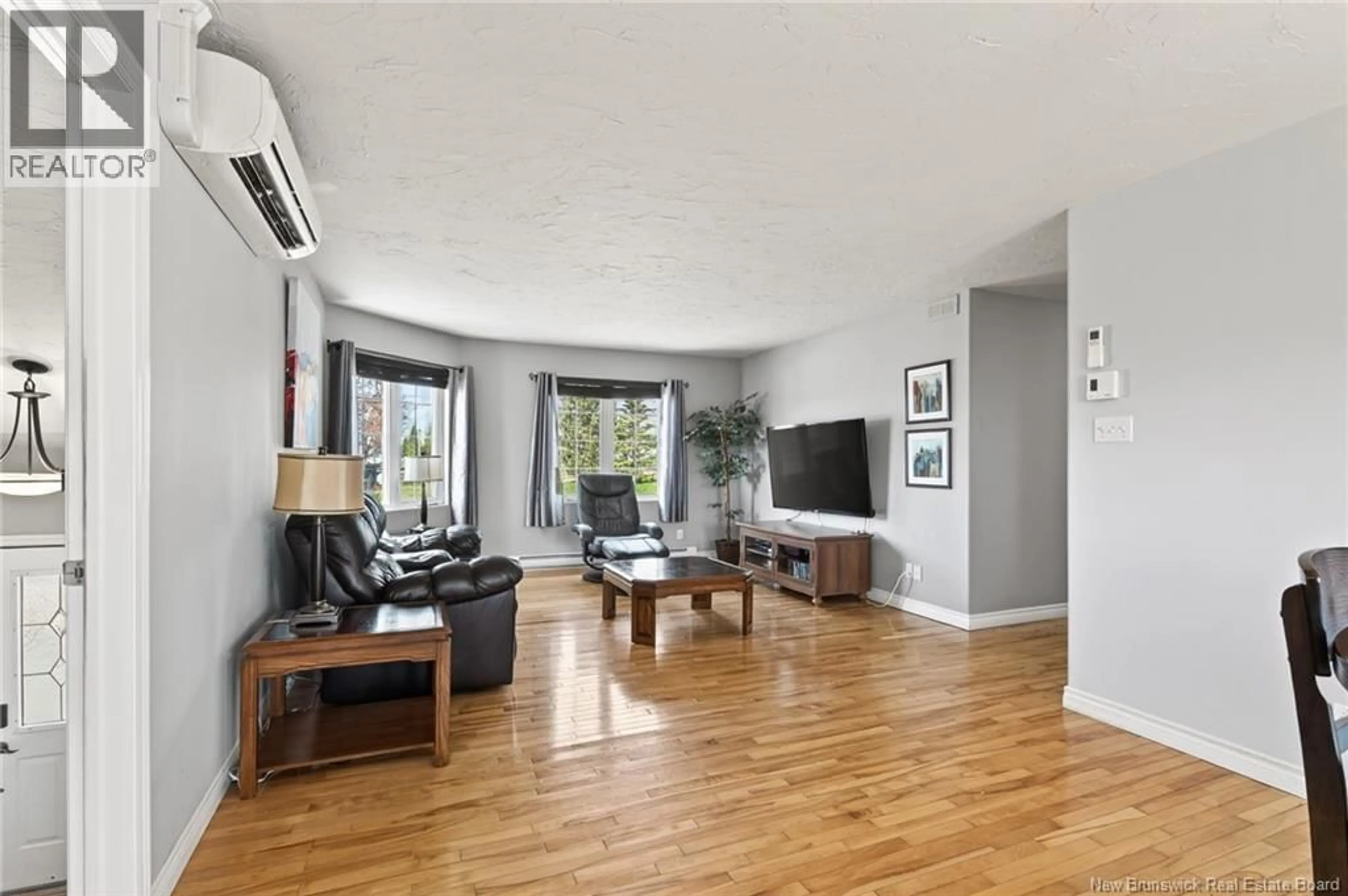 Living room with furniture, wood/laminate floor for 51 PELAGIE STREET, Dieppe New Brunswick E1A7R6