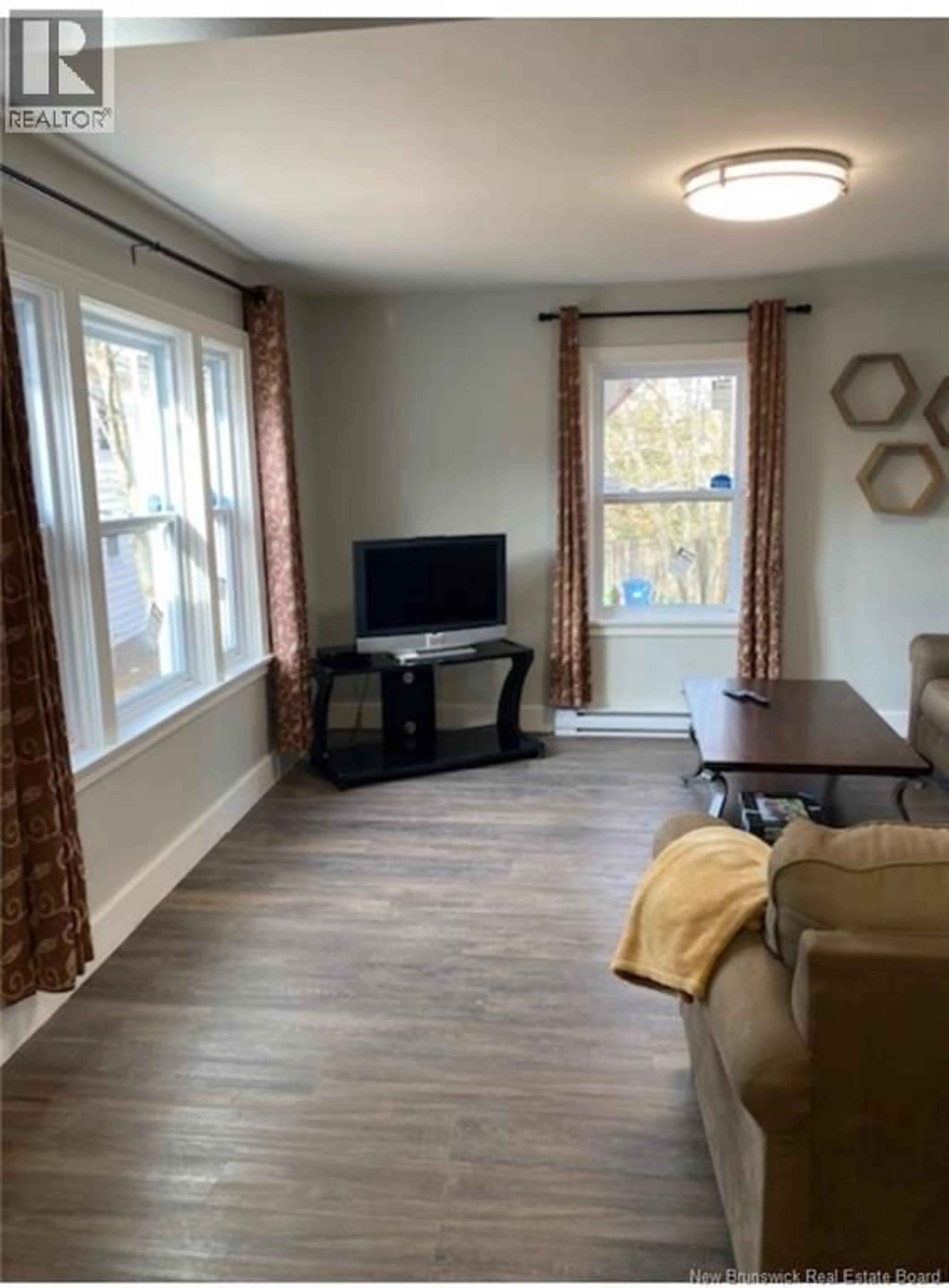 Living room with furniture, wood/laminate floor for 525 ACADIE, Dieppe New Brunswick E1A1J2