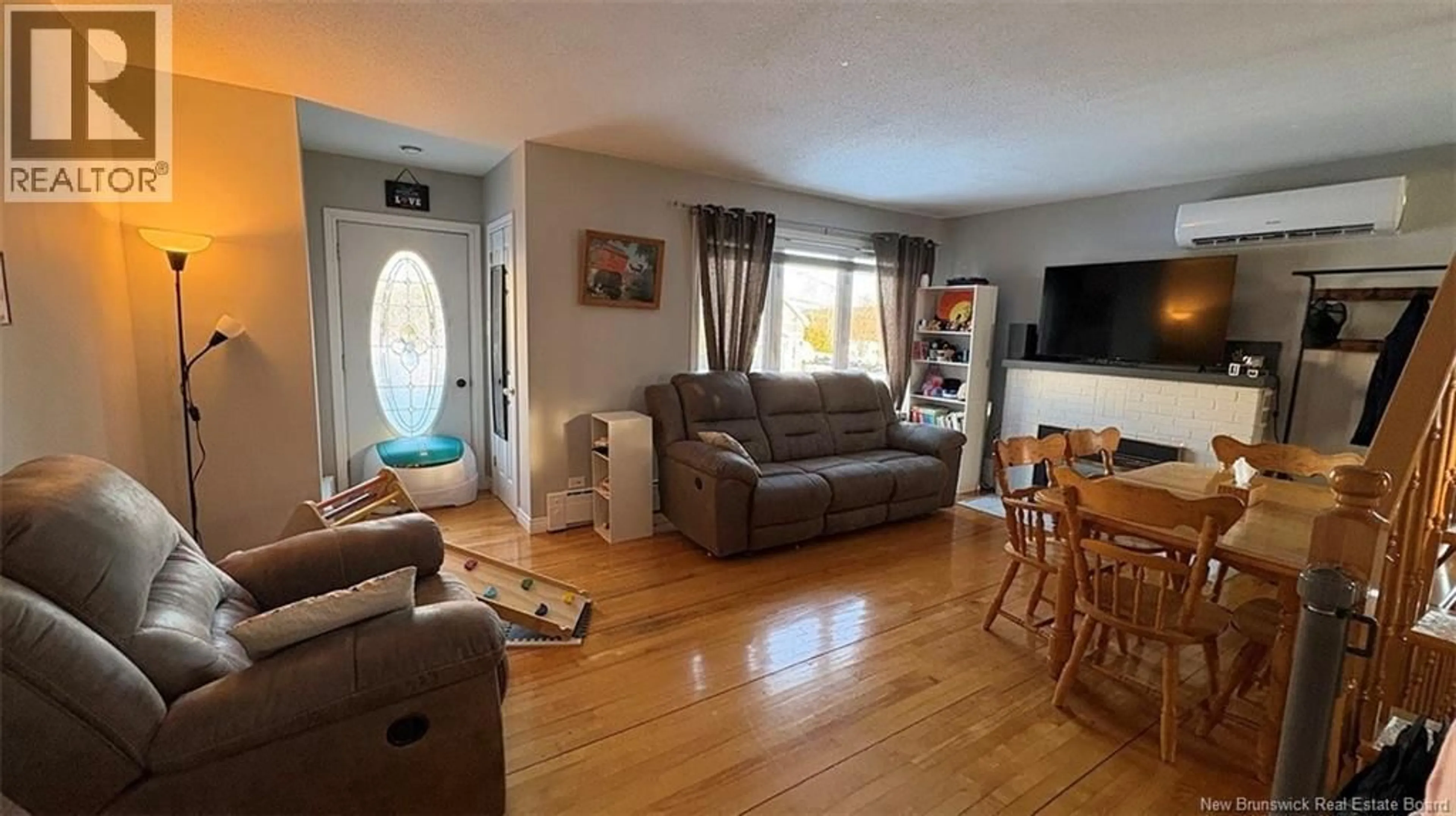Living room with furniture, wood/laminate floor for 28 PHILIPPE AVENUE, Edmundston New Brunswick E3V1R1