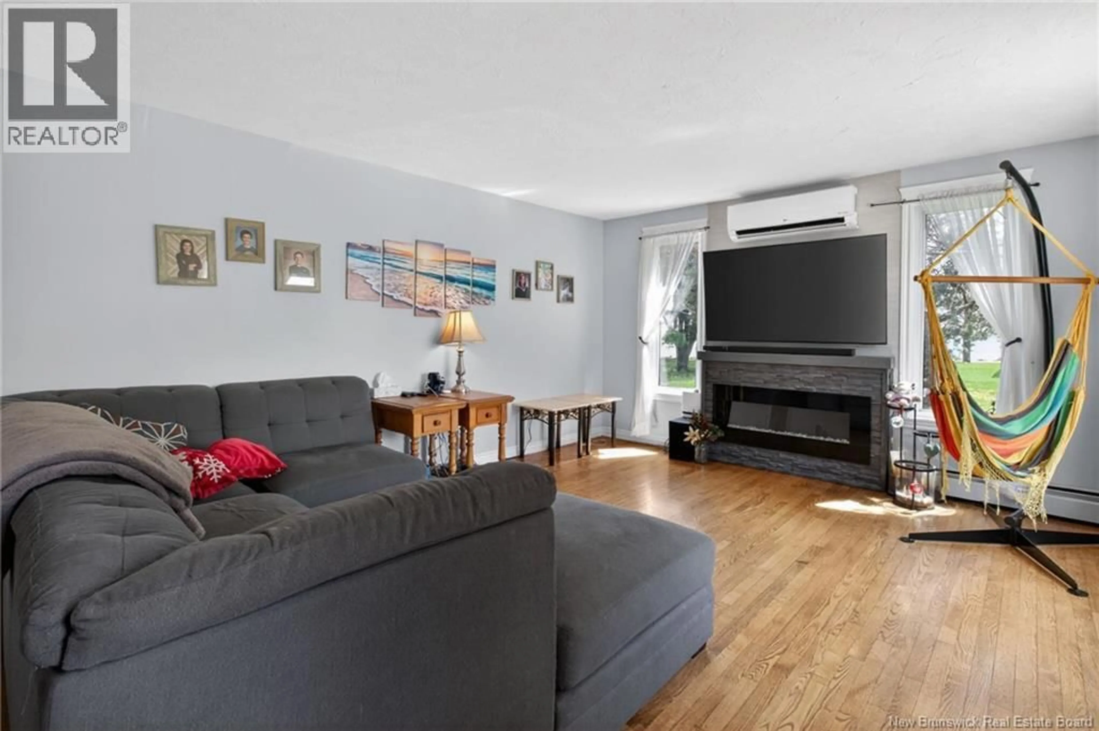 Living room with furniture, wood/laminate floor for 10 CH DES ROCHES, Bouctouche New Brunswick E4S4M2