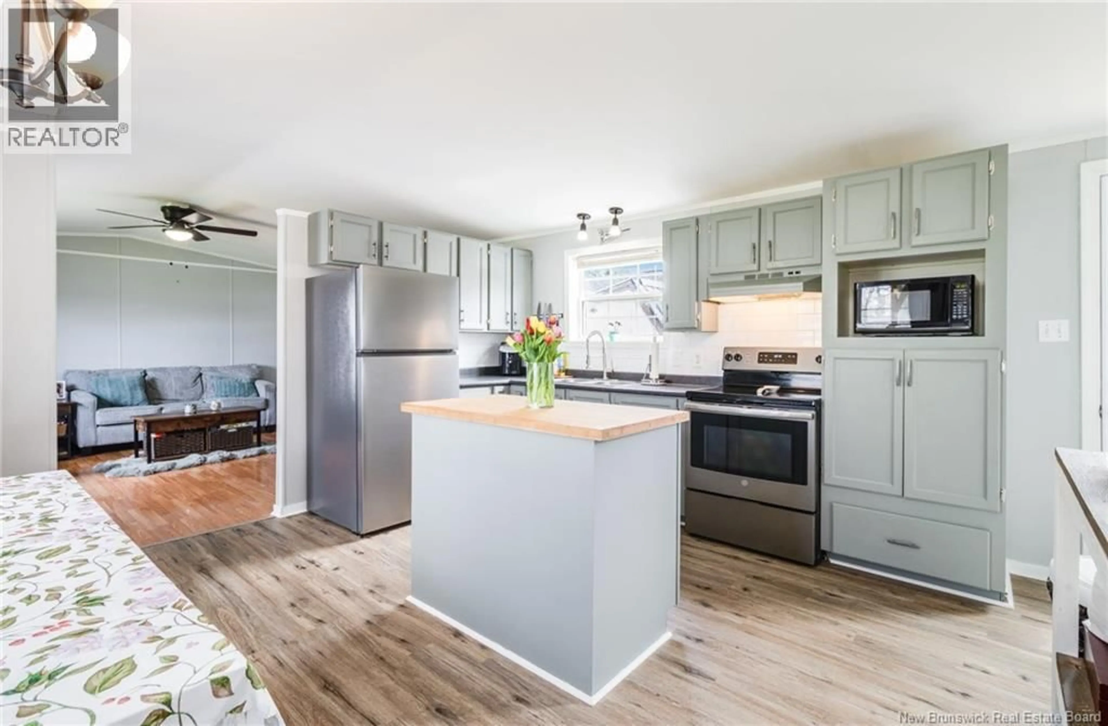 Open concept kitchen, wood/laminate floor for 18 RAMSEY STREET, Lincoln New Brunswick E3B6W9