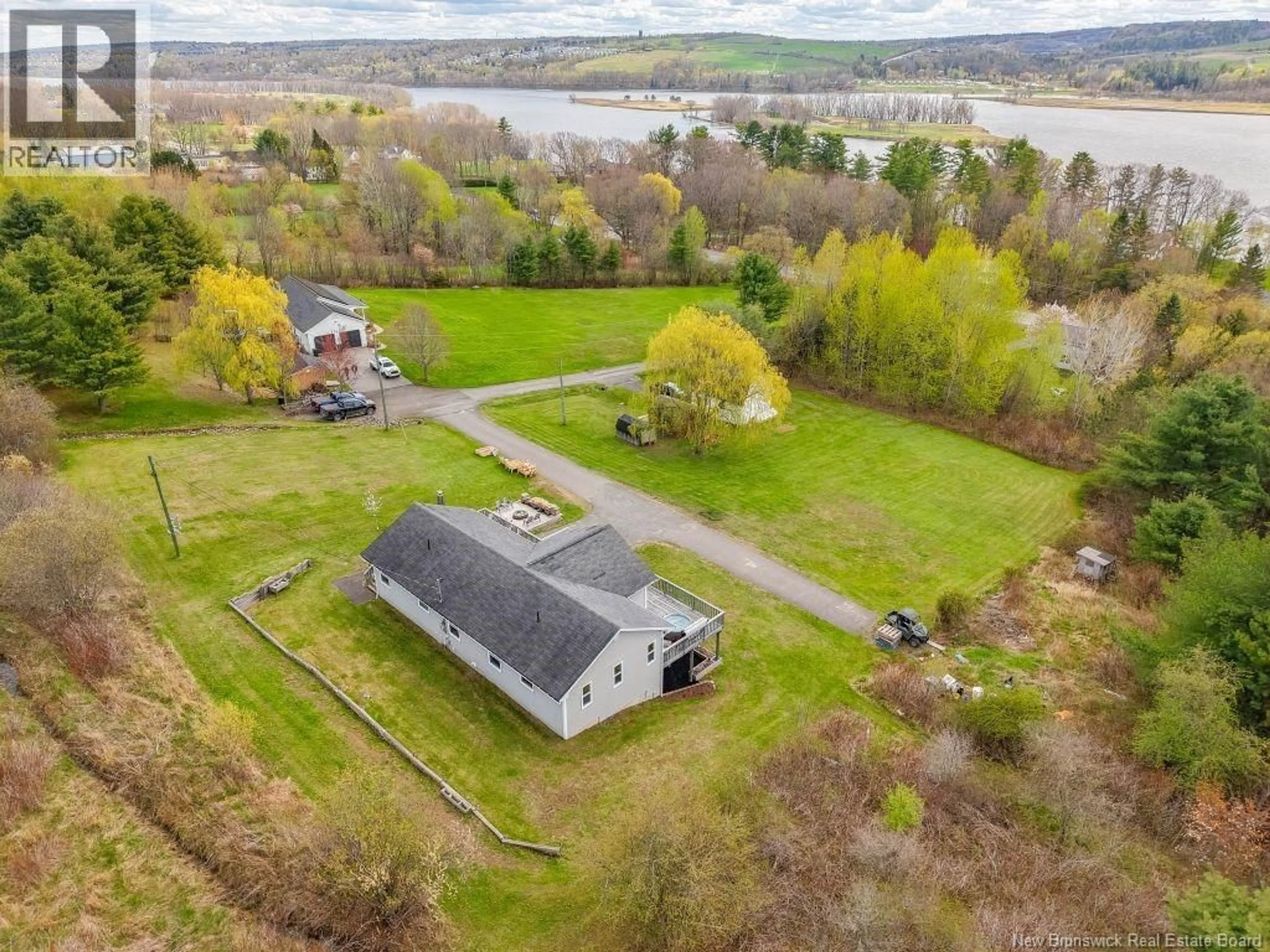 A pic from outside/outdoor area/front of a property/back of a property/a pic from drone, water/lake/river/ocean view for 11 GRAMPS LANE, Douglas New Brunswick E3G7J5