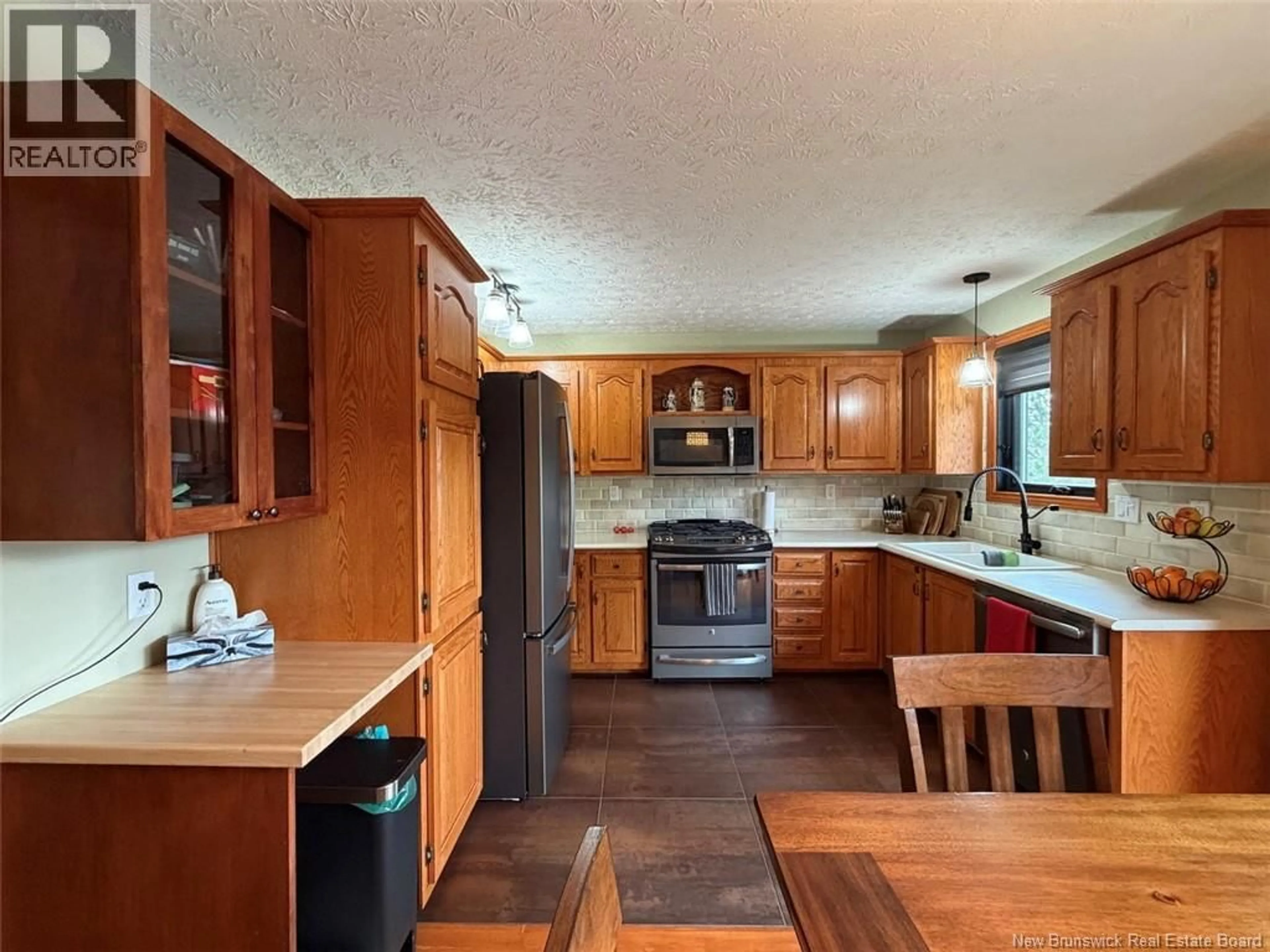 Open concept kitchen, wood/laminate floor for 618 RICEVILLE ROAD, St-Hilaire New Brunswick E3V4T3