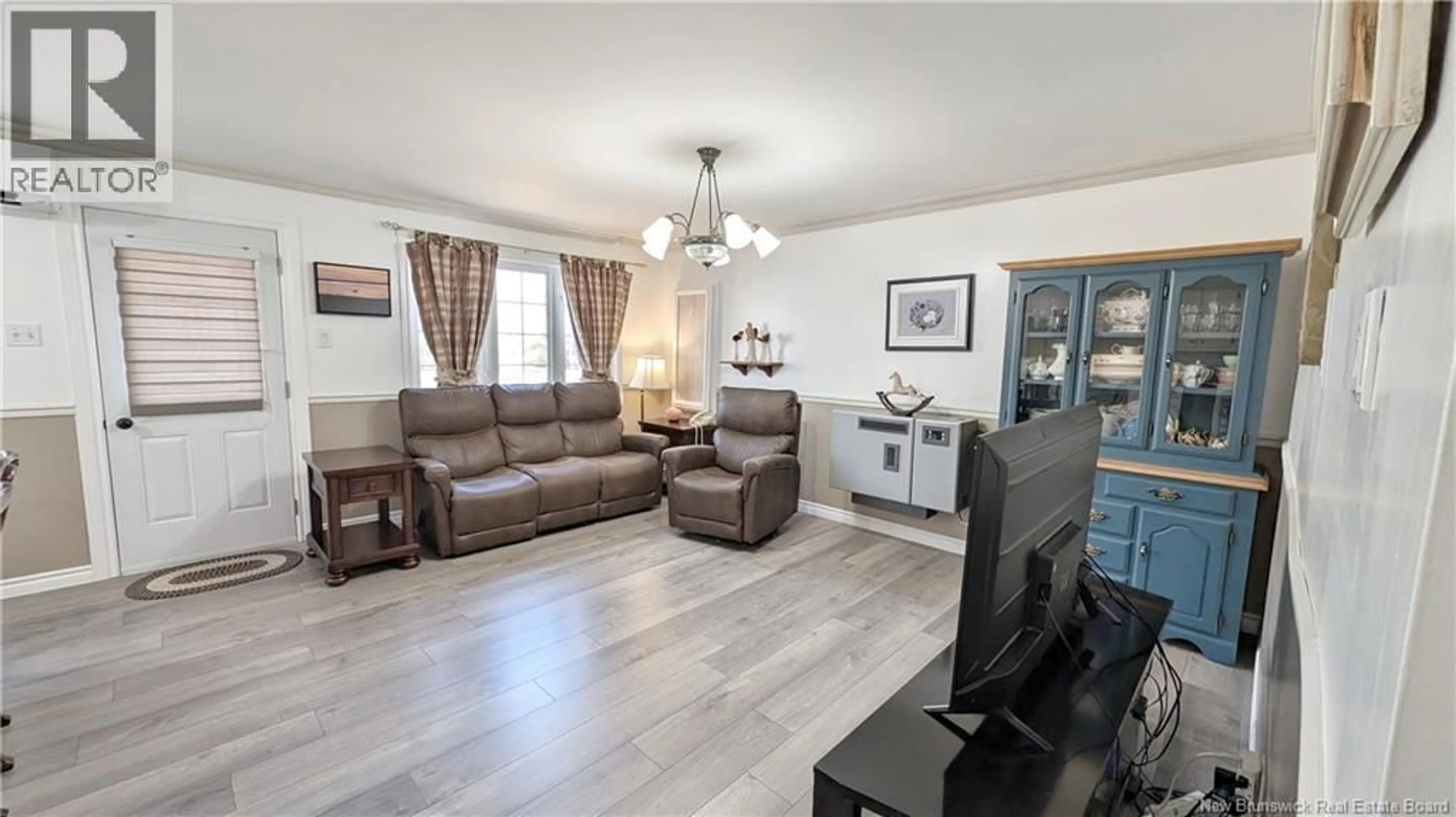 Living room with furniture, wood/laminate floor for 4041 RUE FOSTER STREET, Tracadie New Brunswick E1X1C3