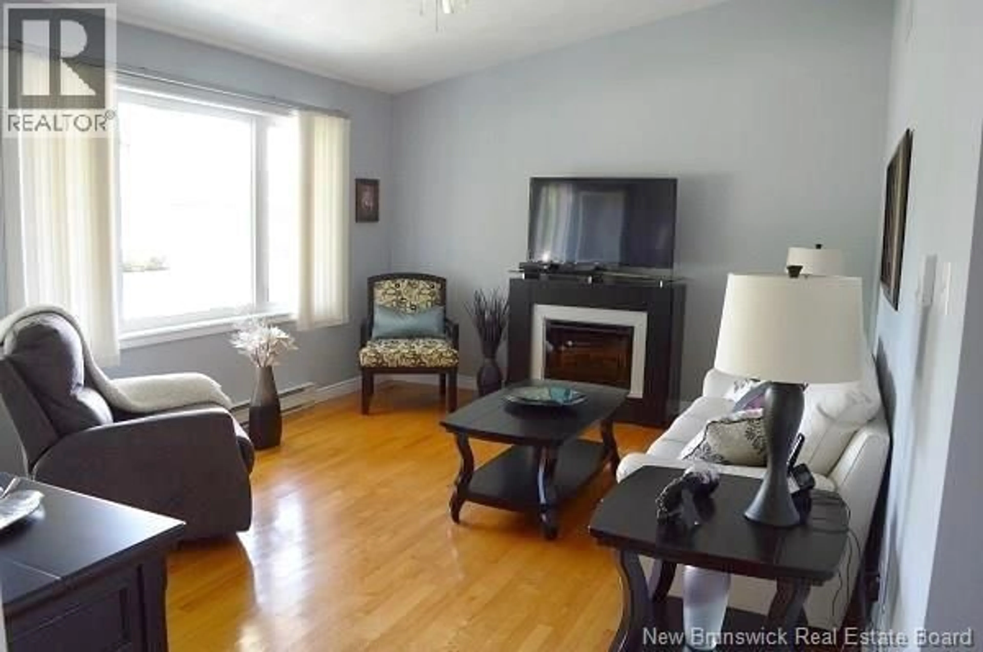 Living room with furniture, wood/laminate floor for 10 KING STREET, Shediac New Brunswick E4P1X9