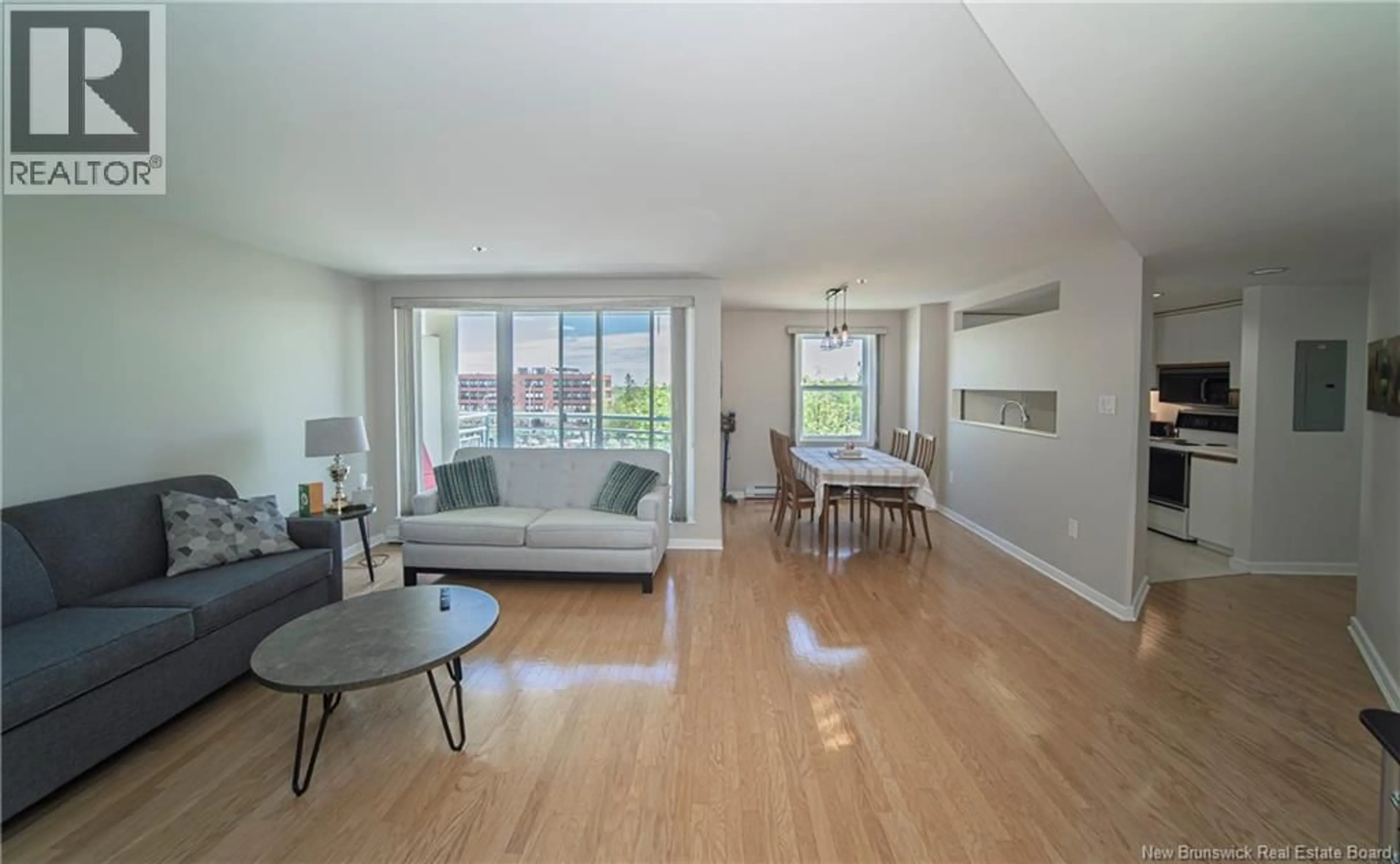 Living room with furniture, wood/laminate floor for 310 - 500 VENUS COURT, Fredericton New Brunswick E3B3A9