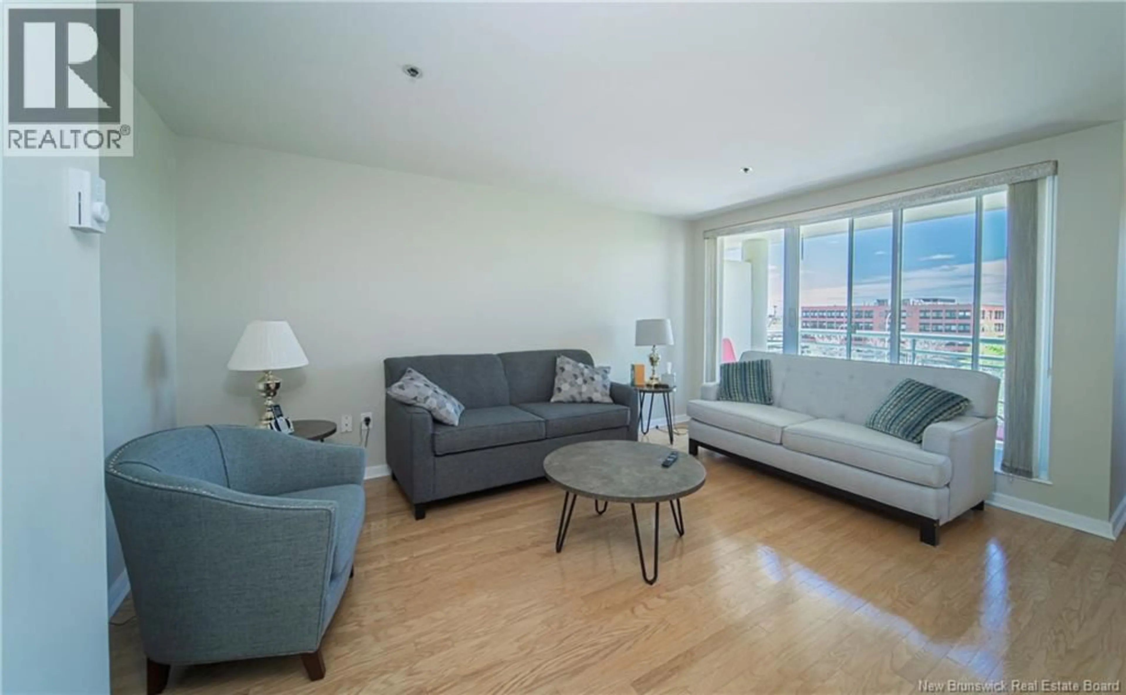 Living room with furniture, wood/laminate floor for 310 - 500 VENUS COURT, Fredericton New Brunswick E3B3A9
