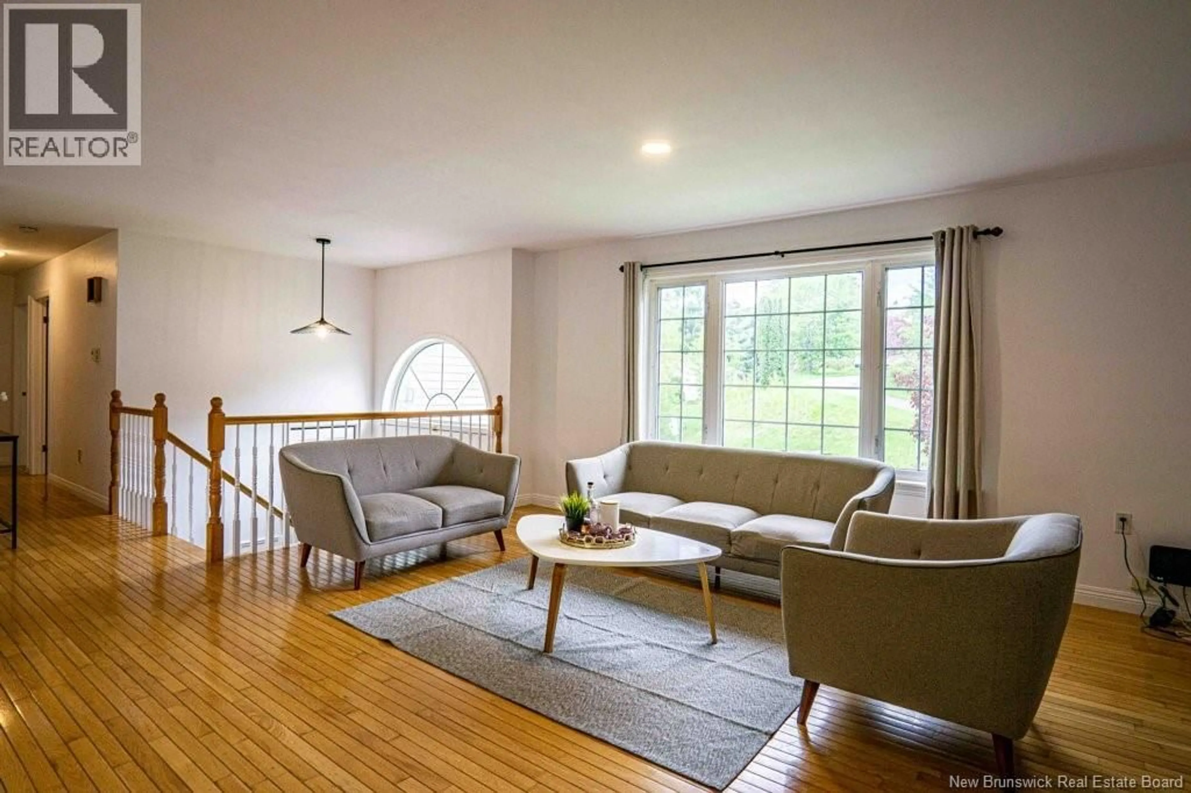 Living room with furniture, wood/laminate floor for 205 KIMBLE DRIVE, Fredericton New Brunswick E3B6L3