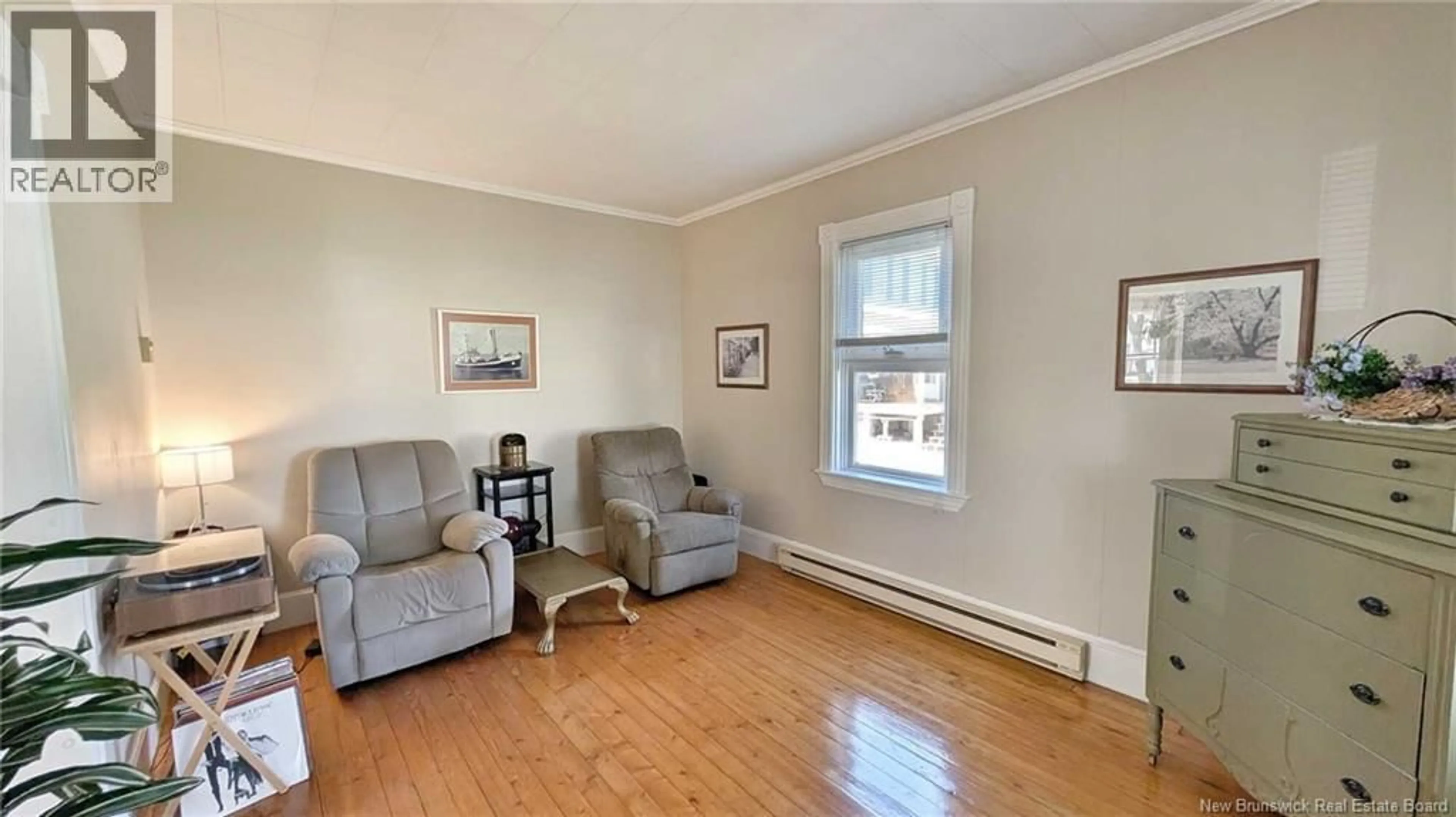Living room with furniture, wood/laminate floor for 216 BOUL. SAINT-PIERRE O, Caraquet New Brunswick E1W1A5