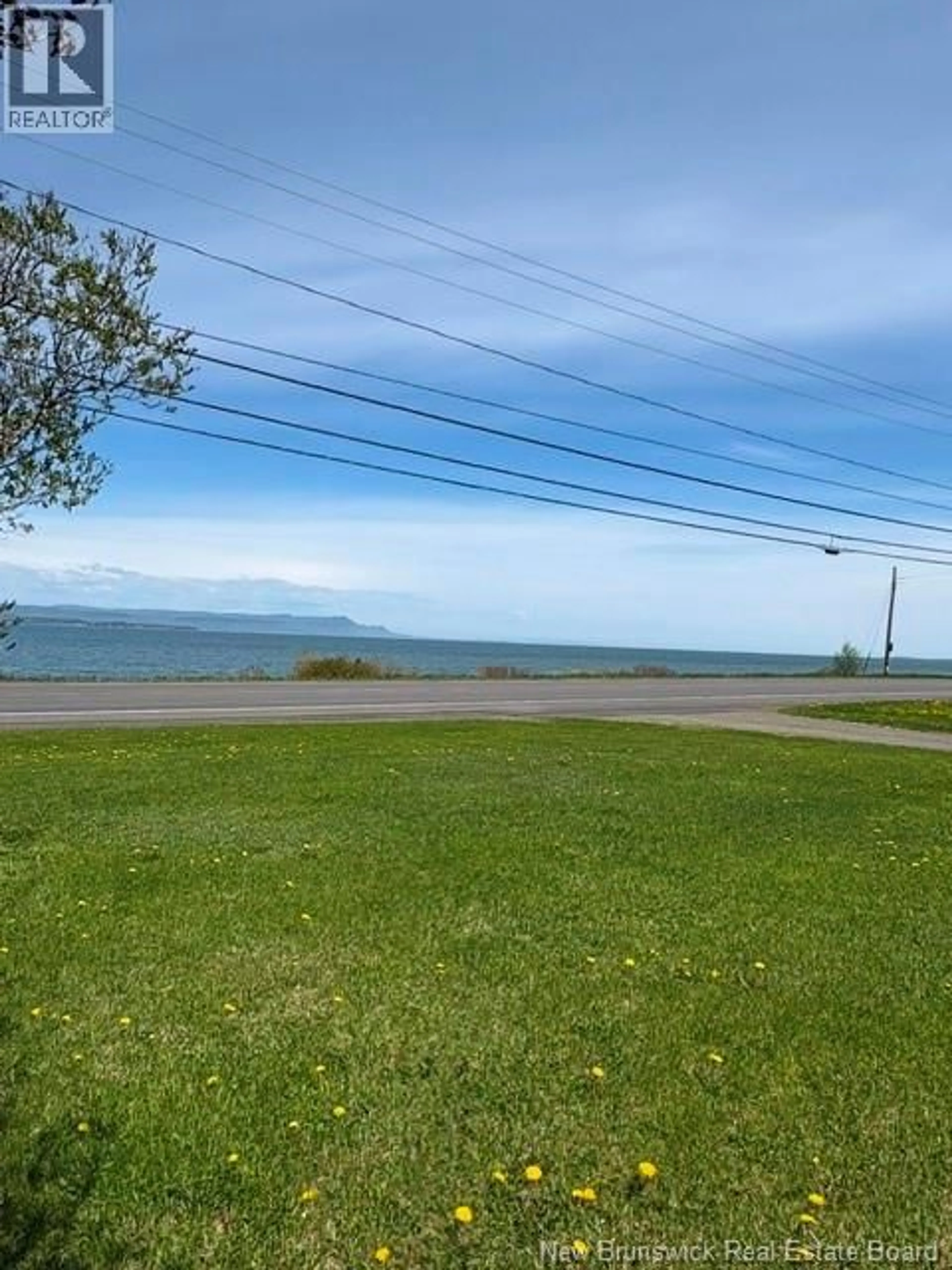 A pic from outside/outdoor area/front of a property/back of a property/a pic from drone, water/lake/river/ocean view for 94 CHALEUR STREET, Charlo New Brunswick E8E2E7