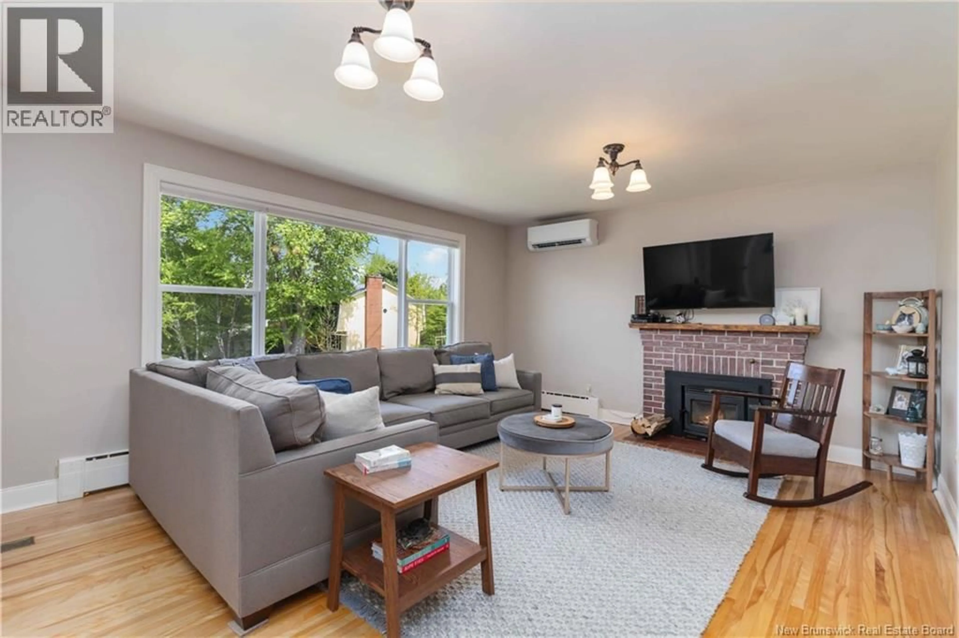 Living room with furniture, wood/laminate floor for 10 SHAMROCK TERRACE, Fredericton New Brunswick E3B2S4