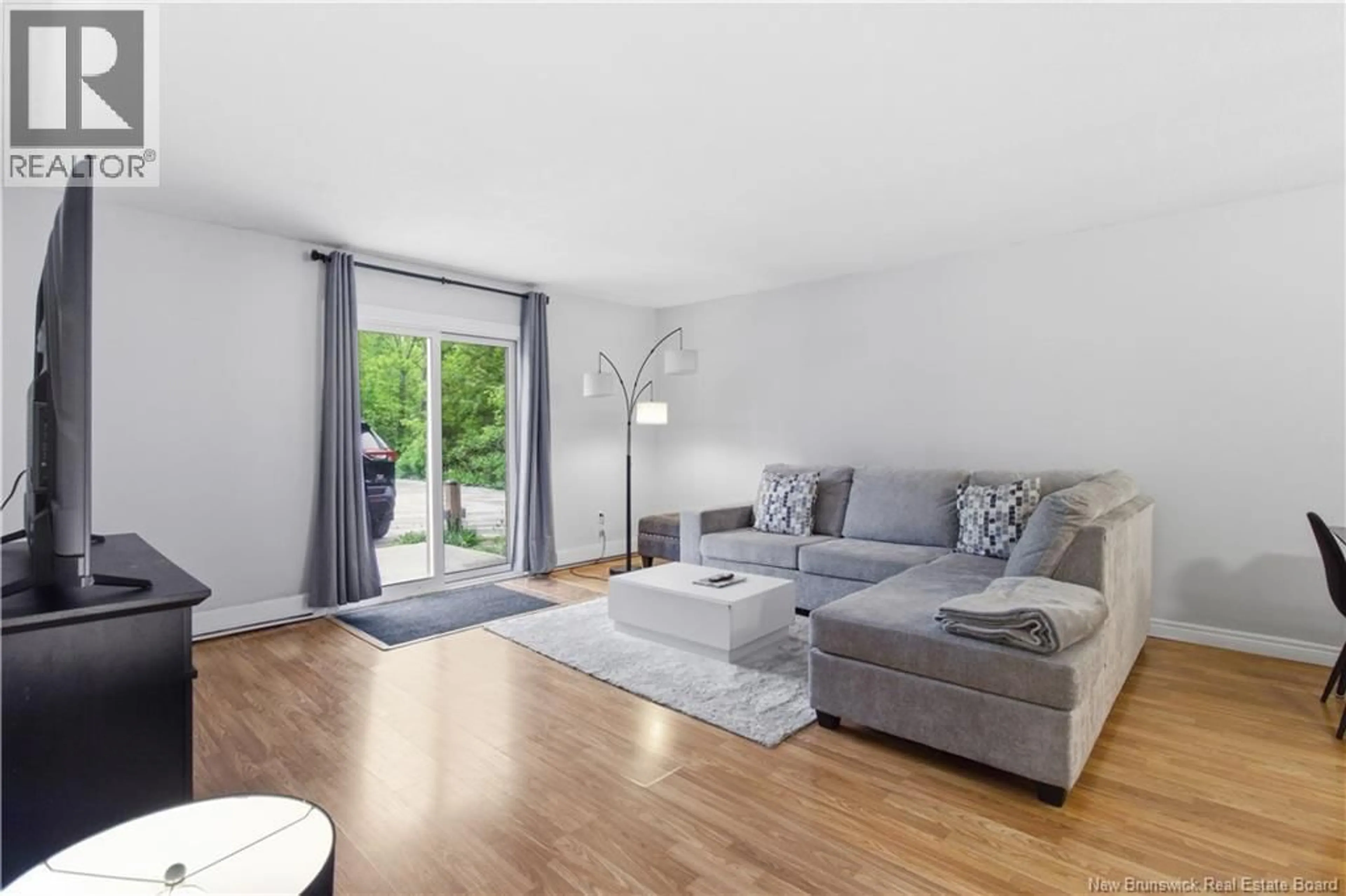 Living room with furniture, wood/laminate floor for 4 - 109 BIGGS STREET, Fredericton New Brunswick E3B6H8
