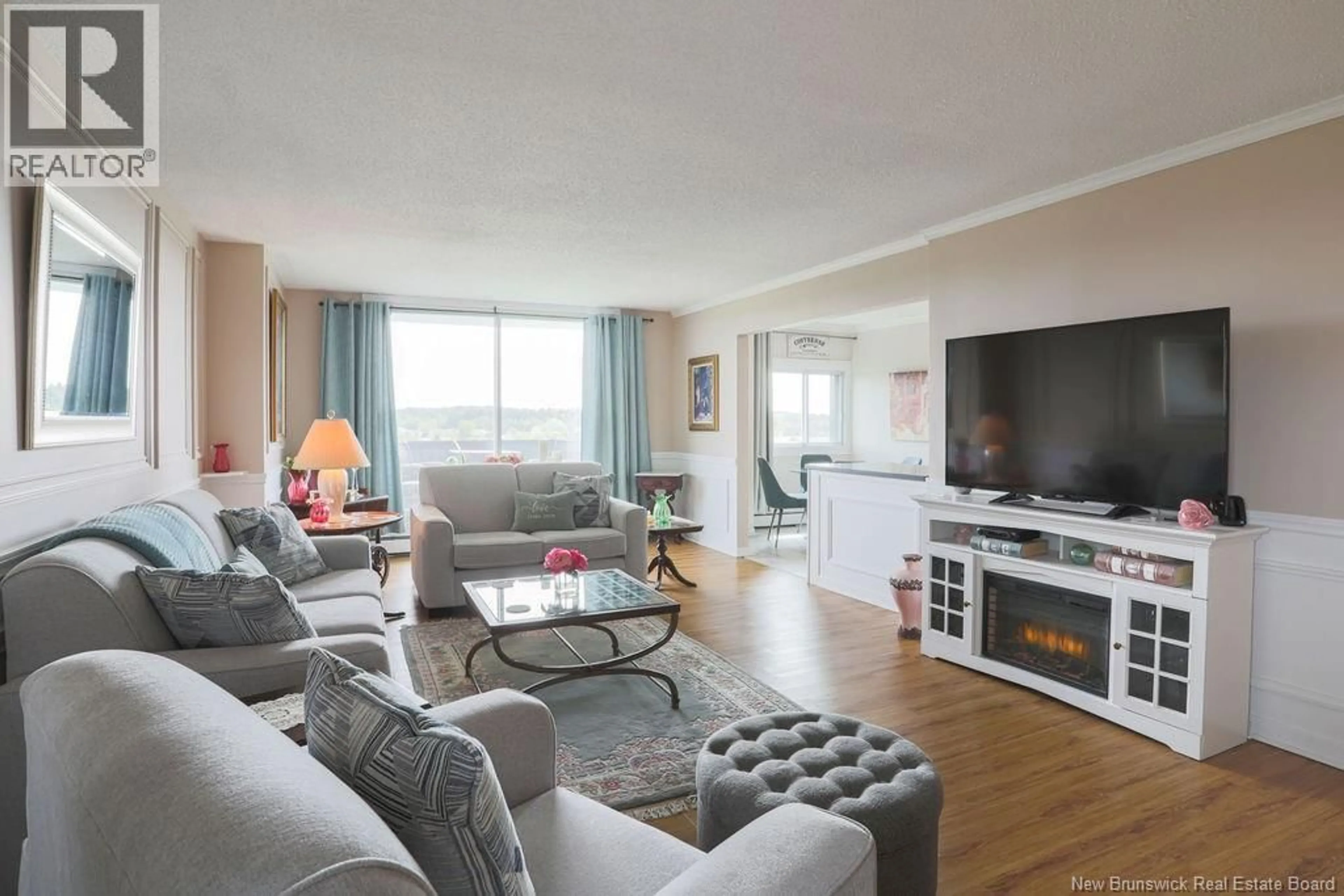 Living room with furniture, wood/laminate floor for 702 - 310 WOODWARD AVENUE, Saint John New Brunswick E2K2L1