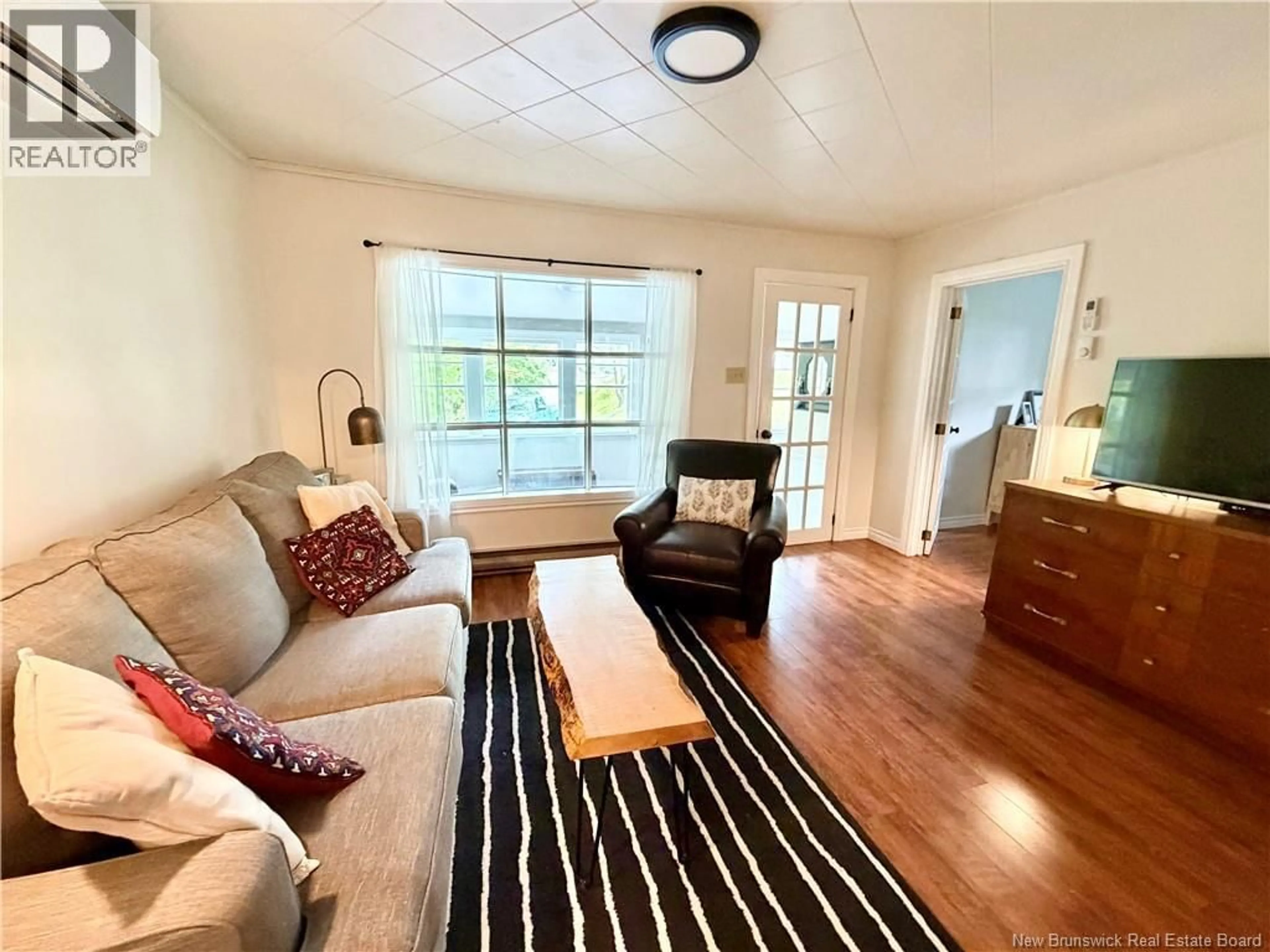 Living room with furniture, wood/laminate floor for 18 KEIRSTEAD AVENUE, Hampton New Brunswick E5N5A3