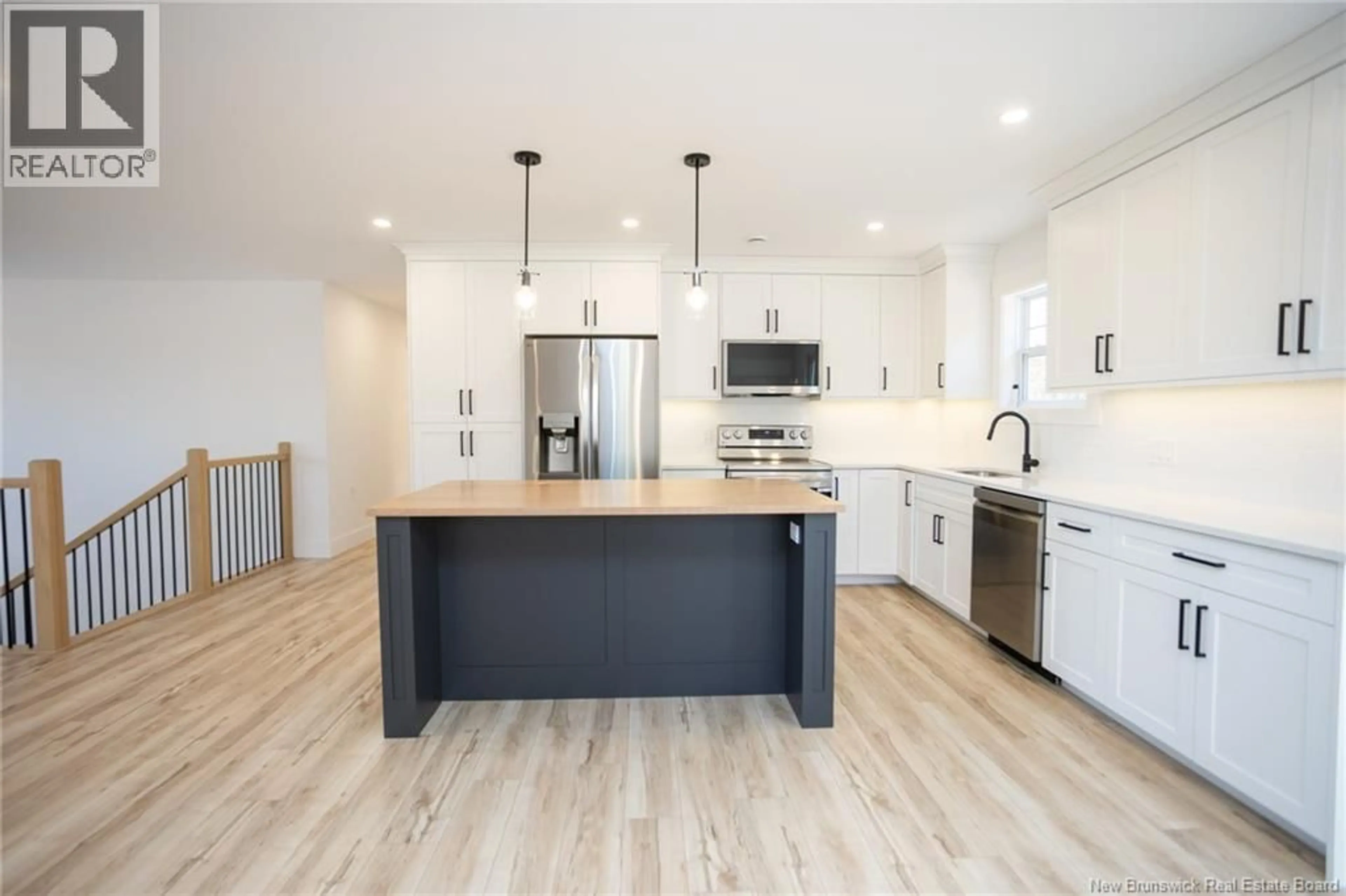 Open concept kitchen, wood/laminate floor for 50 BERRY DRIVE, Rusagonis New Brunswick E3B0V9