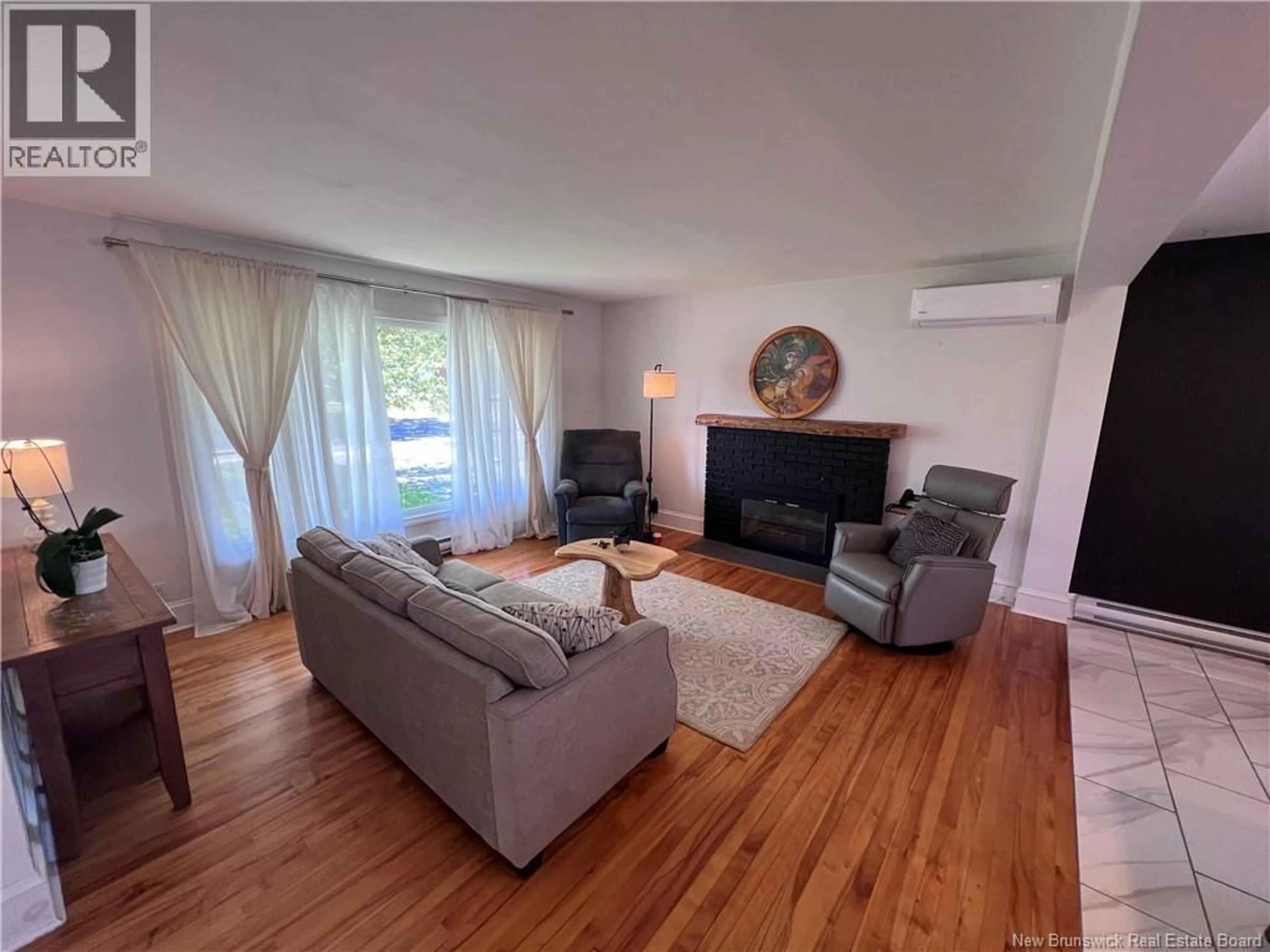 Living room with furniture, wood/laminate floor for 70 ALWARD STREET, Saint John New Brunswick E2K2K2
