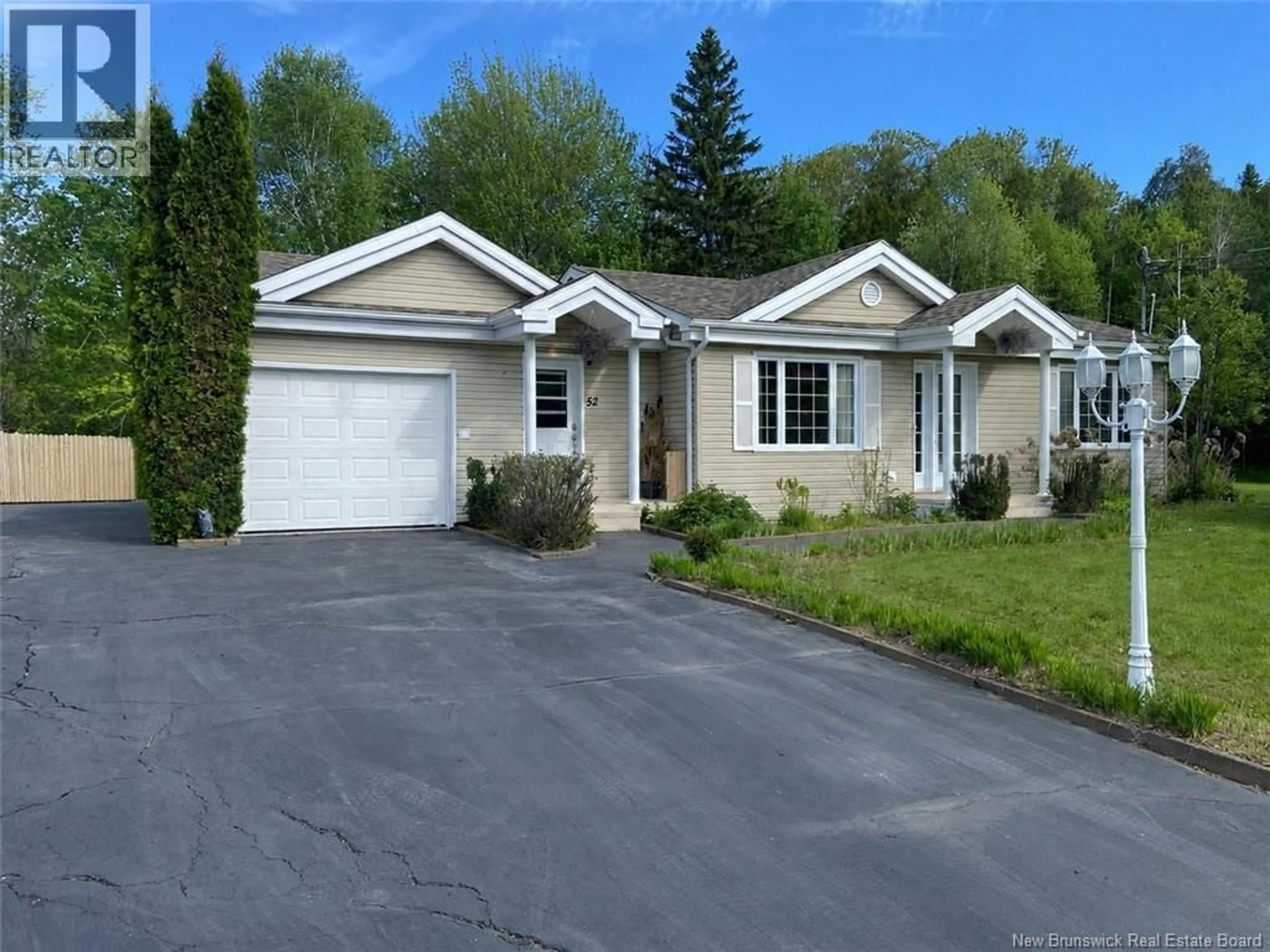 Home with vinyl exterior material, street for 52 RAYMOND STREET, Edmundston New Brunswick E3V4Z7