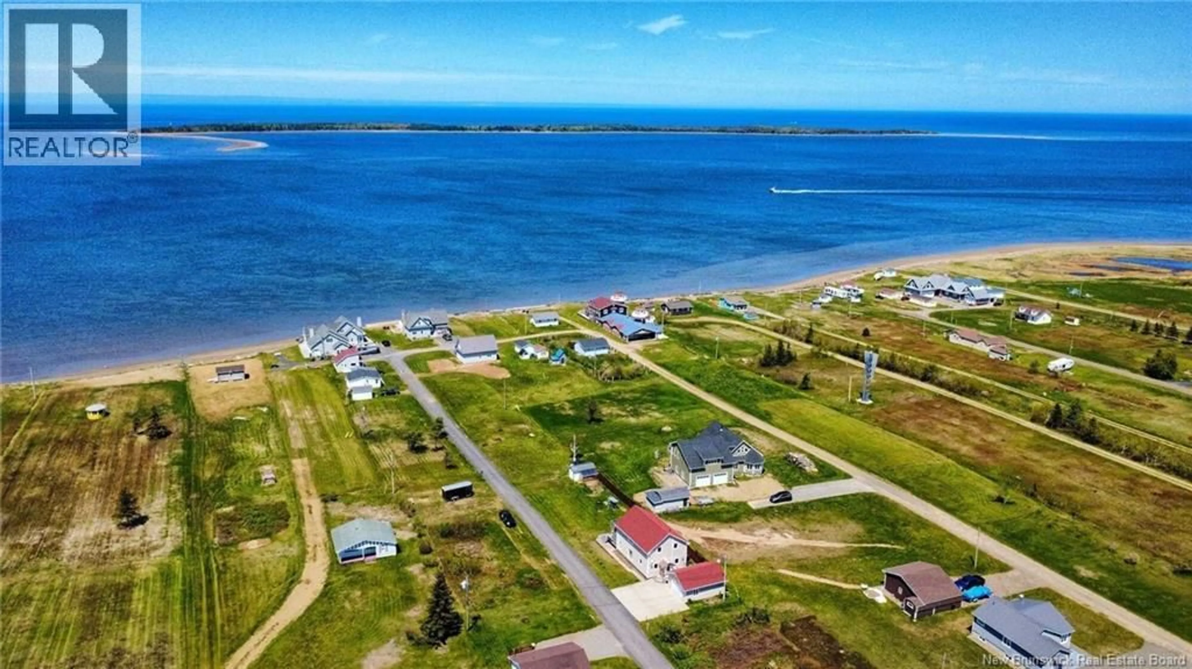 A pic from outside/outdoor area/front of a property/back of a property/a pic from drone, water/lake/river/ocean view for 10 RUE DE LA DUNE, Caraquet New Brunswick E1W1B5