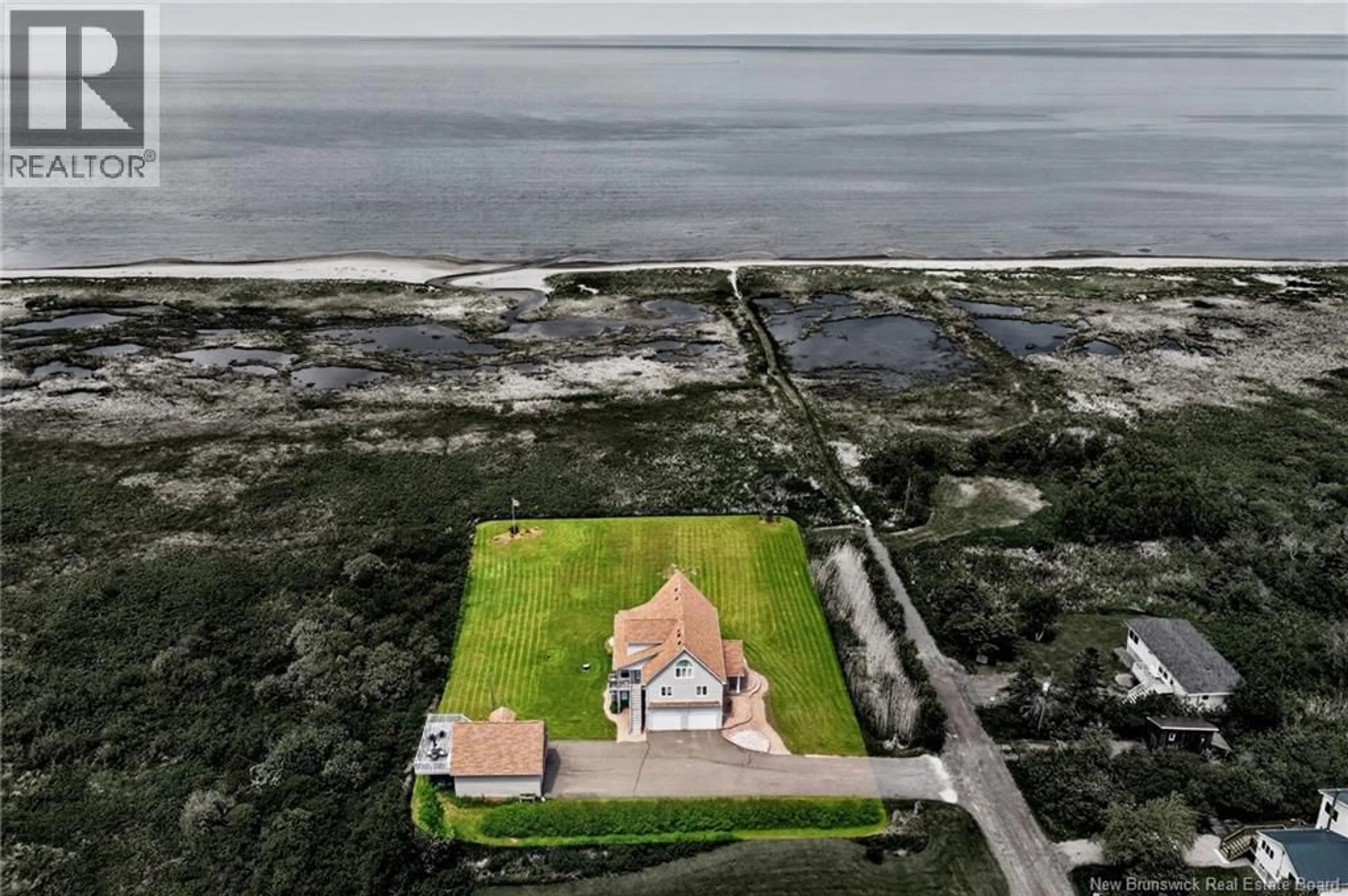A pic from outside/outdoor area/front of a property/back of a property/a pic from drone, water/lake/river/ocean view for 128 BEAU RIVAGE DRIVE, Cap-Pelé New Brunswick E4N1M6