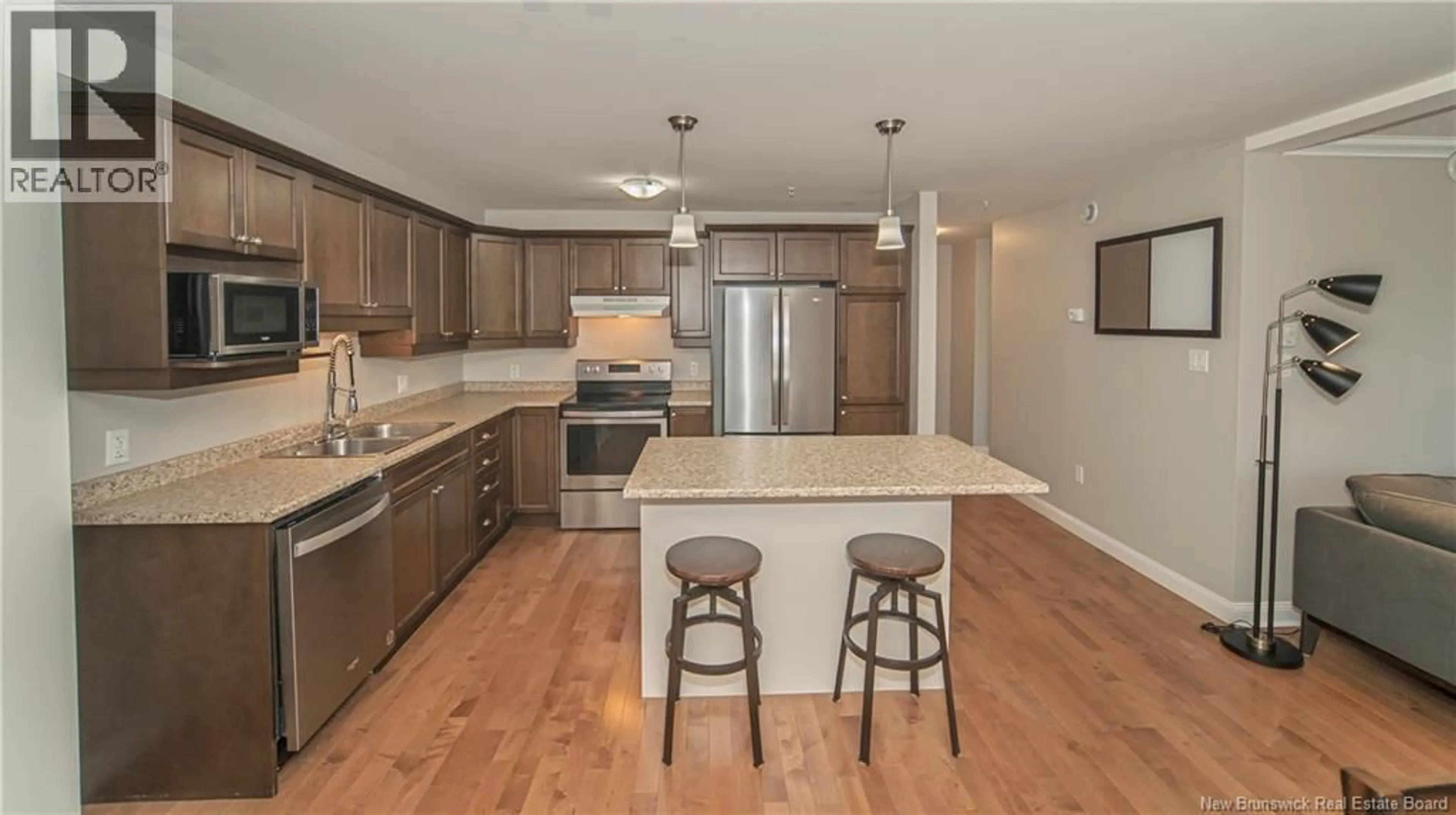 Open concept kitchen, wood/laminate floor for 209 - 65 BRAYSON BOULEVARD, Oromocto New Brunswick E2V0J2
