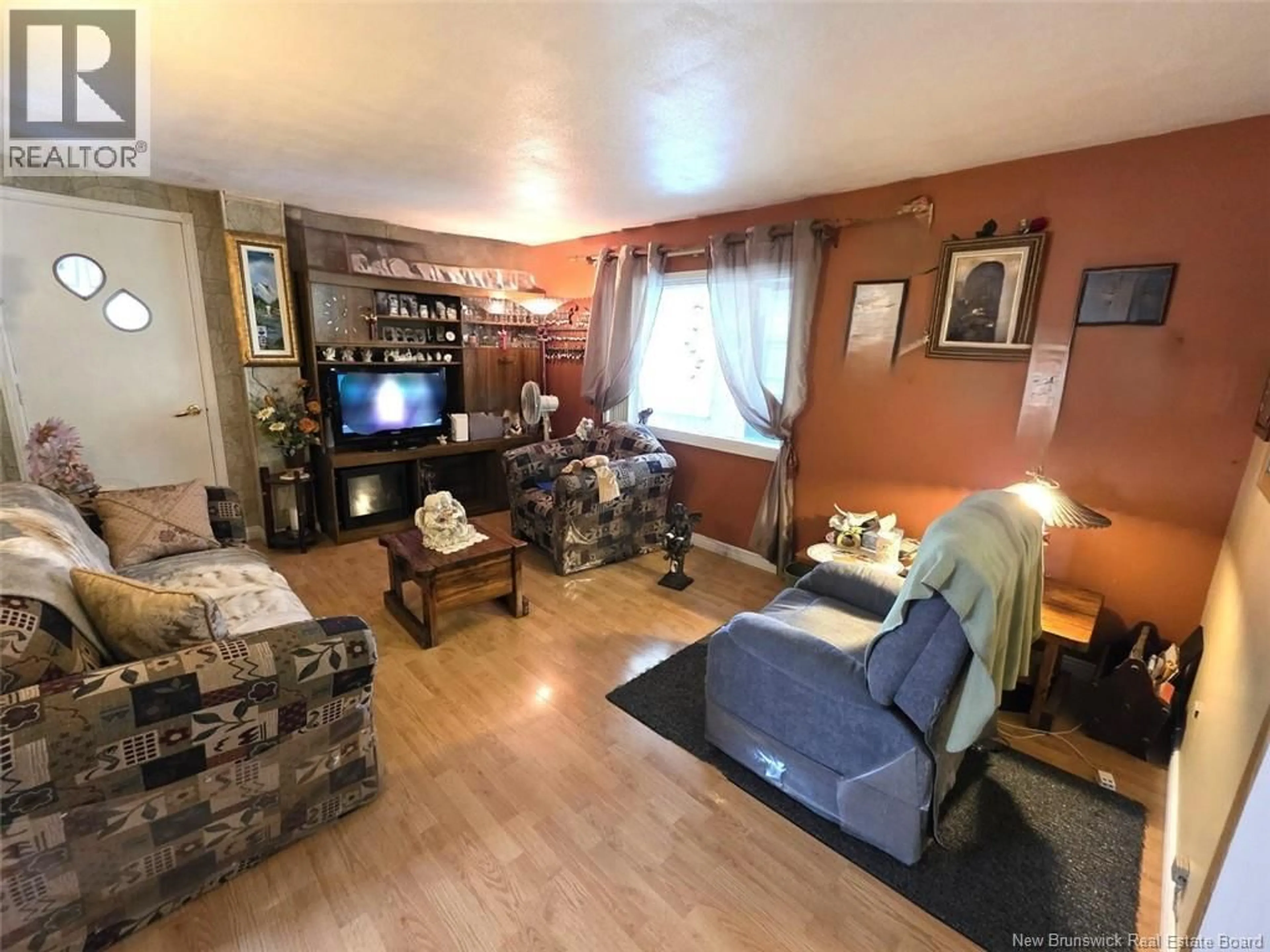 Living room with furniture, wood/laminate floor for 460 CANADA ROAD, Edmundston New Brunswick E3V1W4