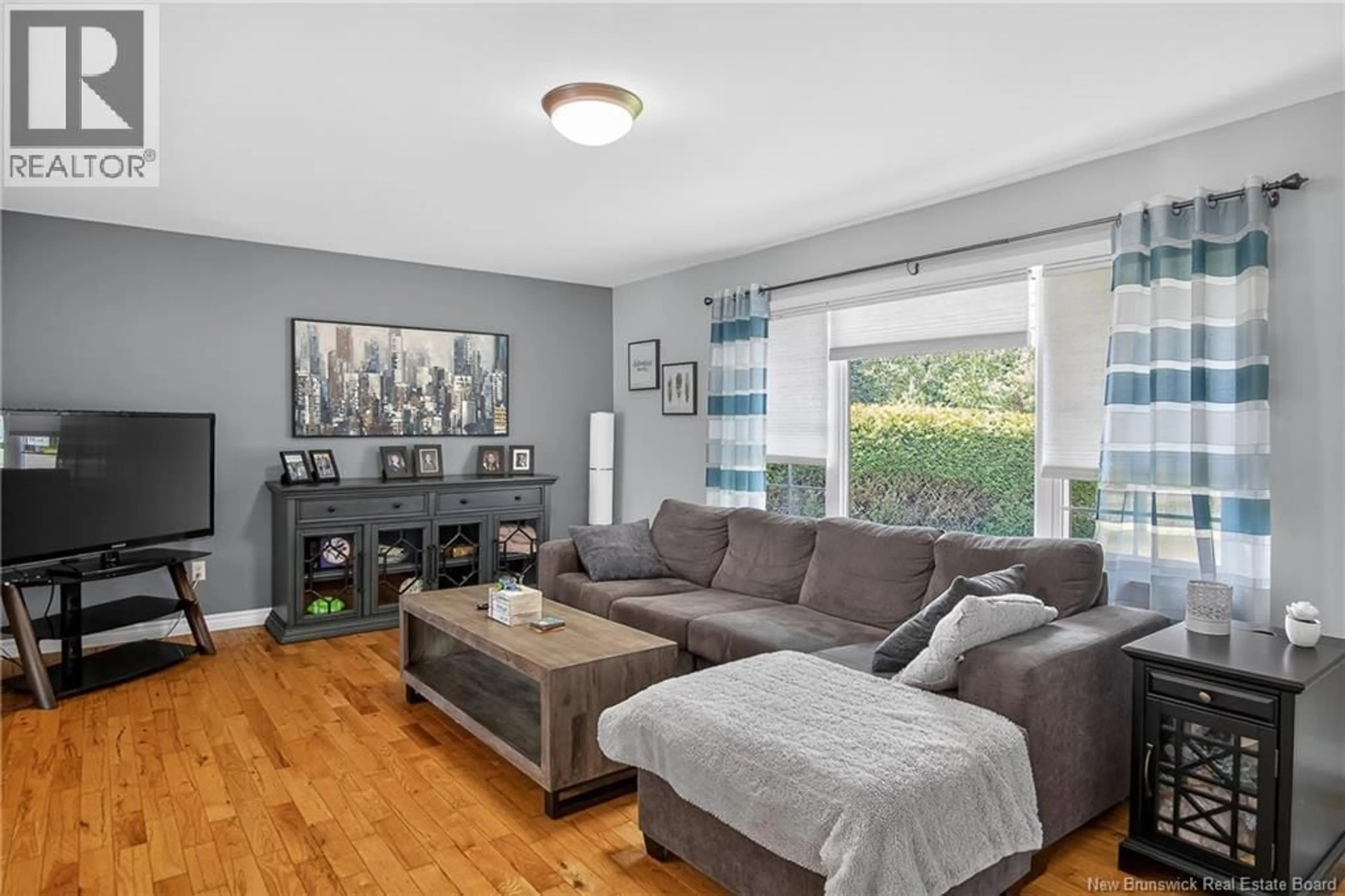 Living room with furniture, wood/laminate floor for 42 LILA COURT, Quispamsis New Brunswick E2E6B1