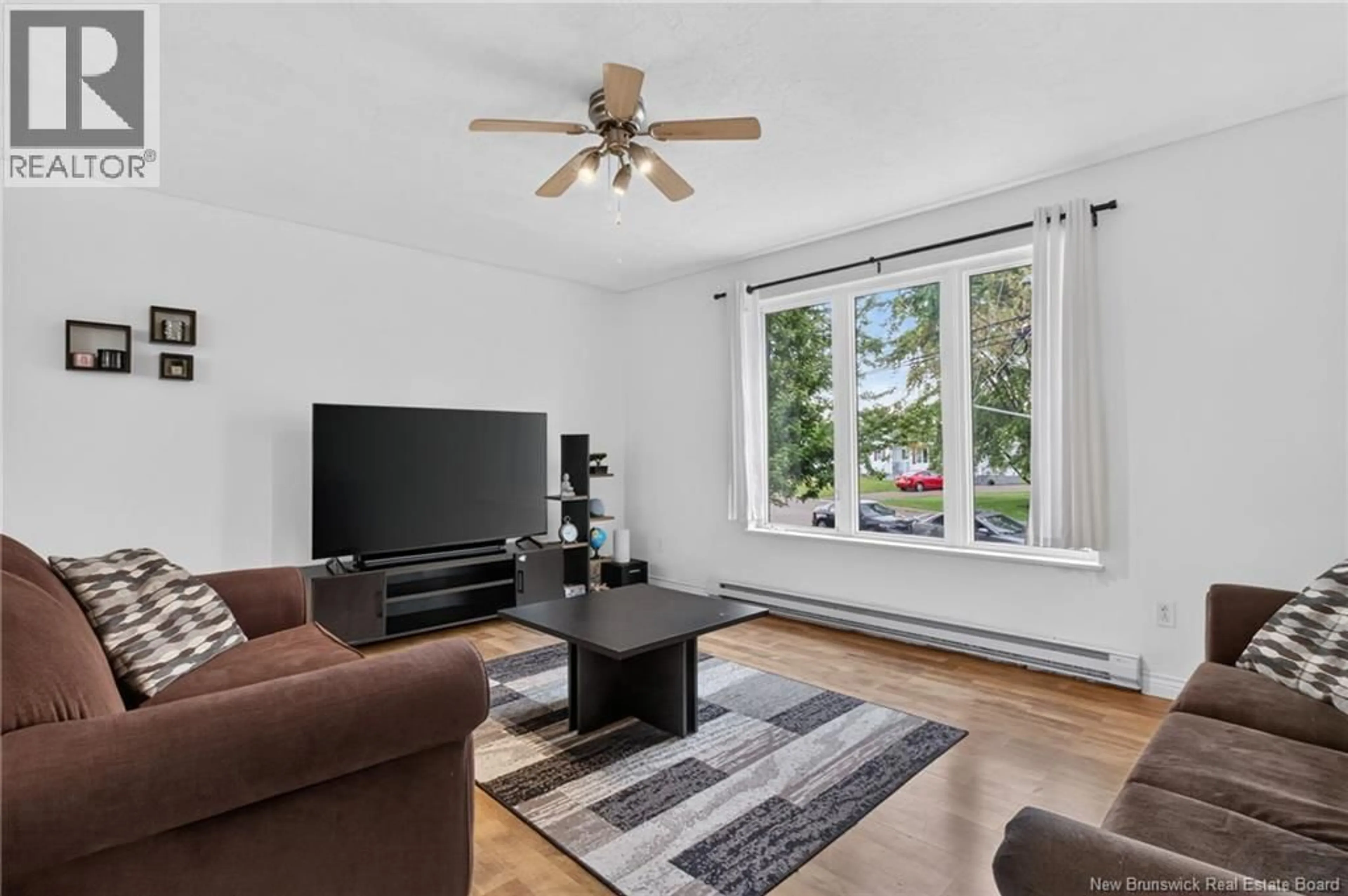 Living room with furniture, wood/laminate floor for 55-57 GALBRAITH CRESCENT, Moncton New Brunswick E1G2G4
