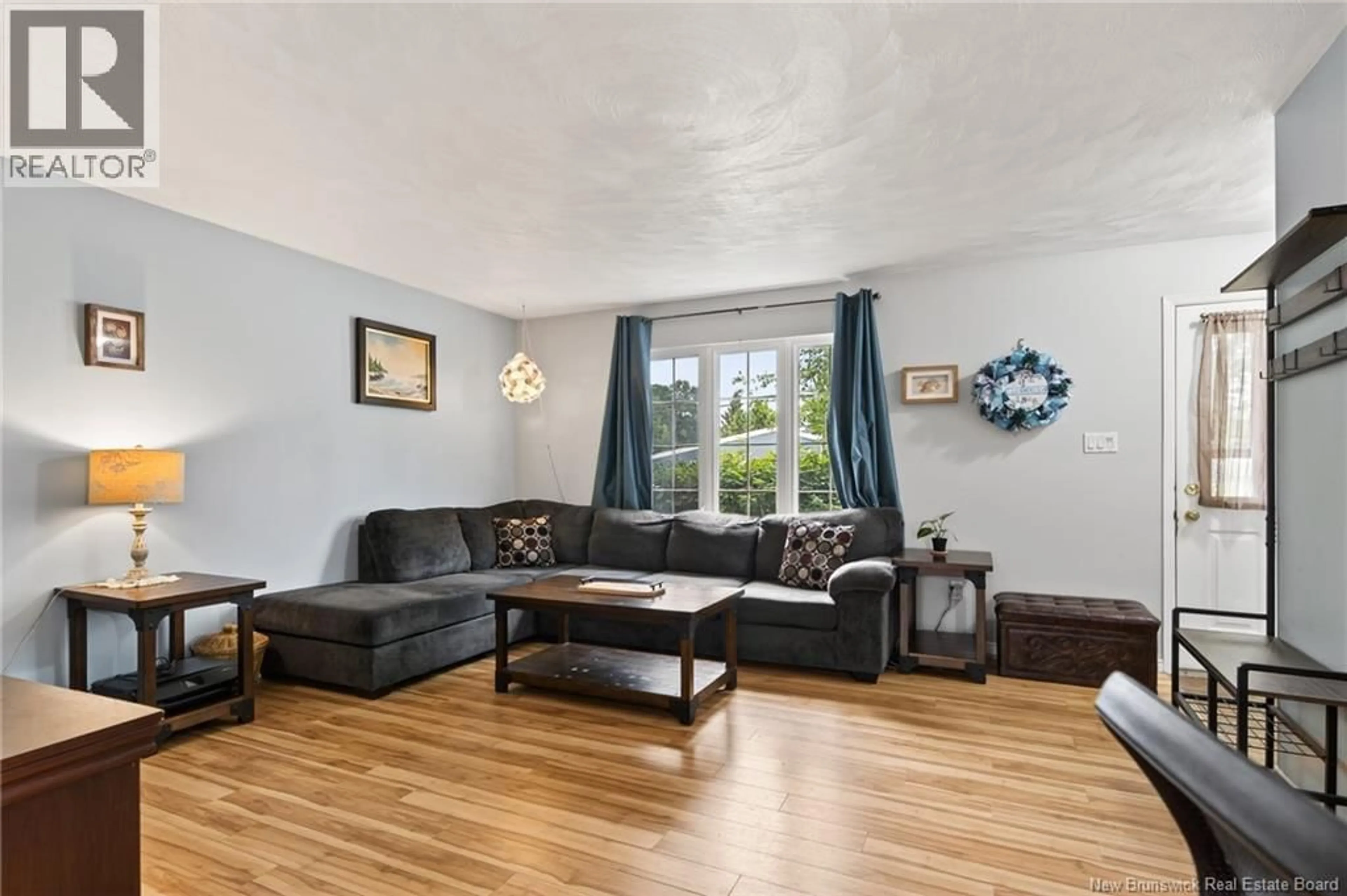 Living room with furniture, wood/laminate floor for 233 KENDRA STREET, Moncton New Brunswick E1C8Y4