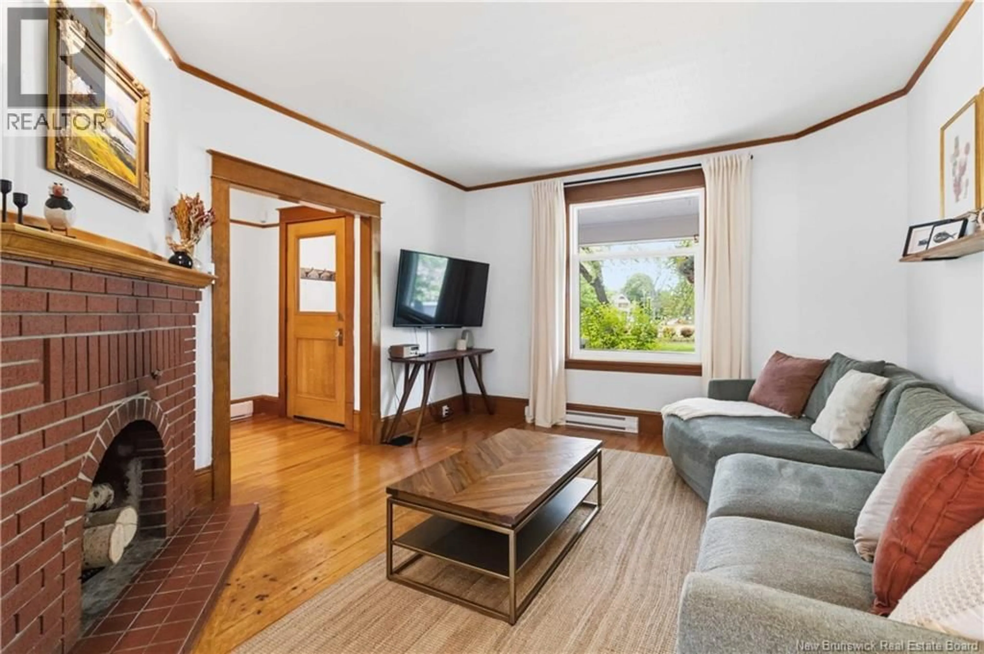 Living room with furniture, wood/laminate floor for 244 CAMERON STREET, Moncton New Brunswick E1C5Z3