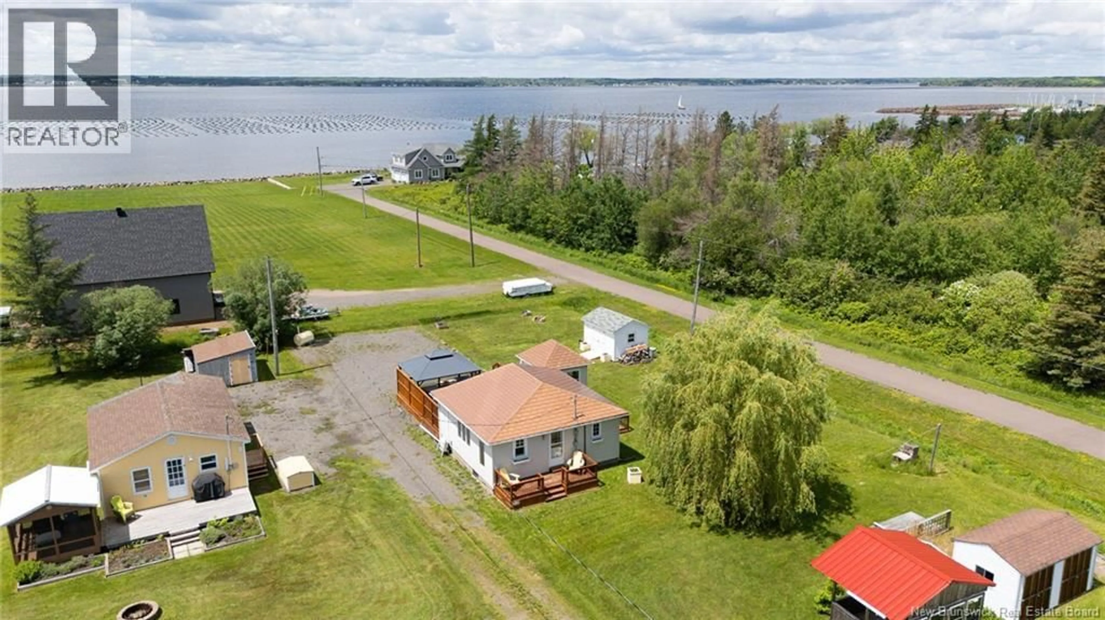A pic from outside/outdoor area/front of a property/back of a property/a pic from drone, water/lake/river/ocean view for 32 ALLEE DES COPAINS, Grande-Digue New Brunswick E4R5N7
