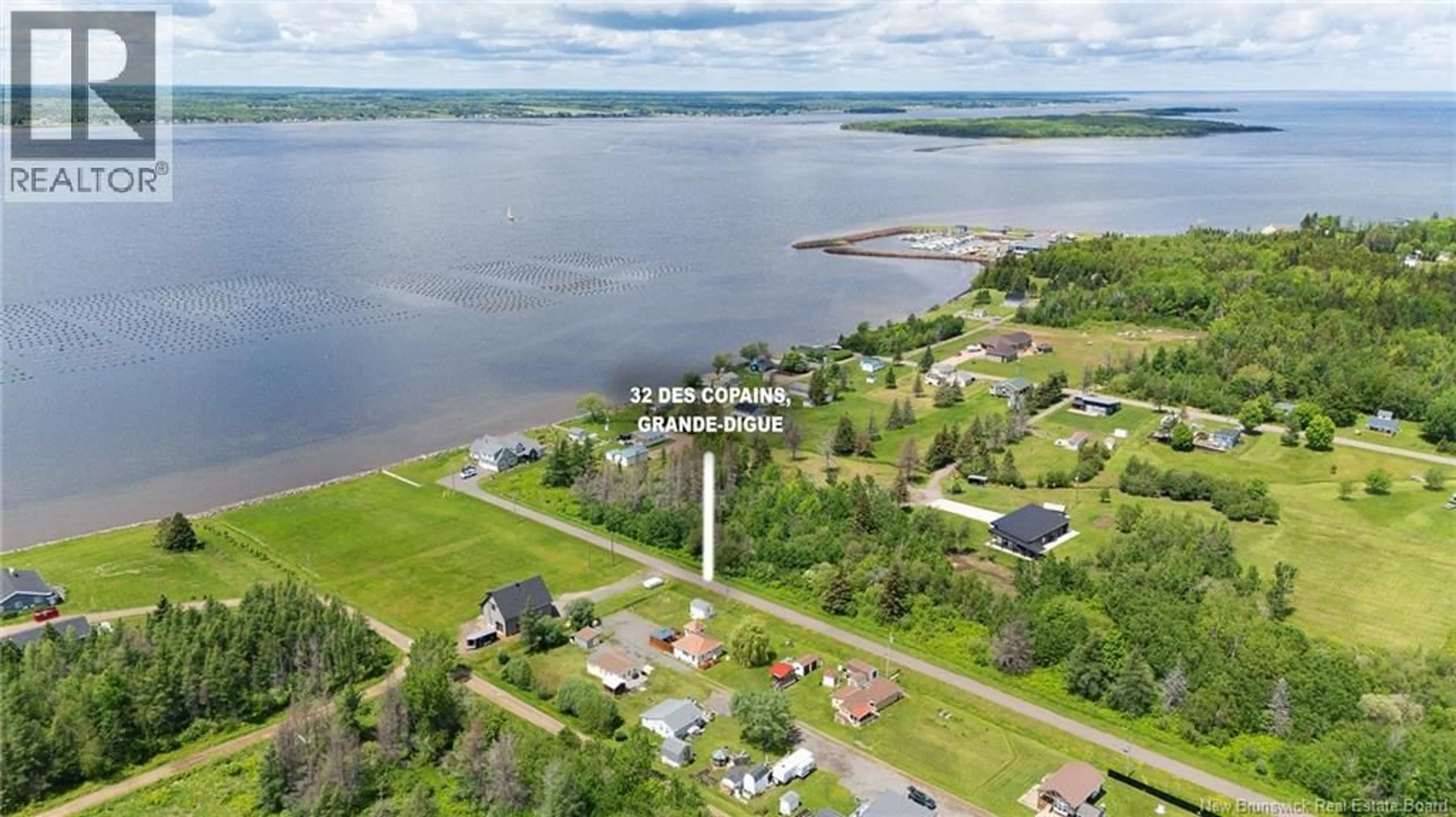 A pic from outside/outdoor area/front of a property/back of a property/a pic from drone, water/lake/river/ocean view for 32 ALLEE DES COPAINS, Grande-Digue New Brunswick E4R5N7