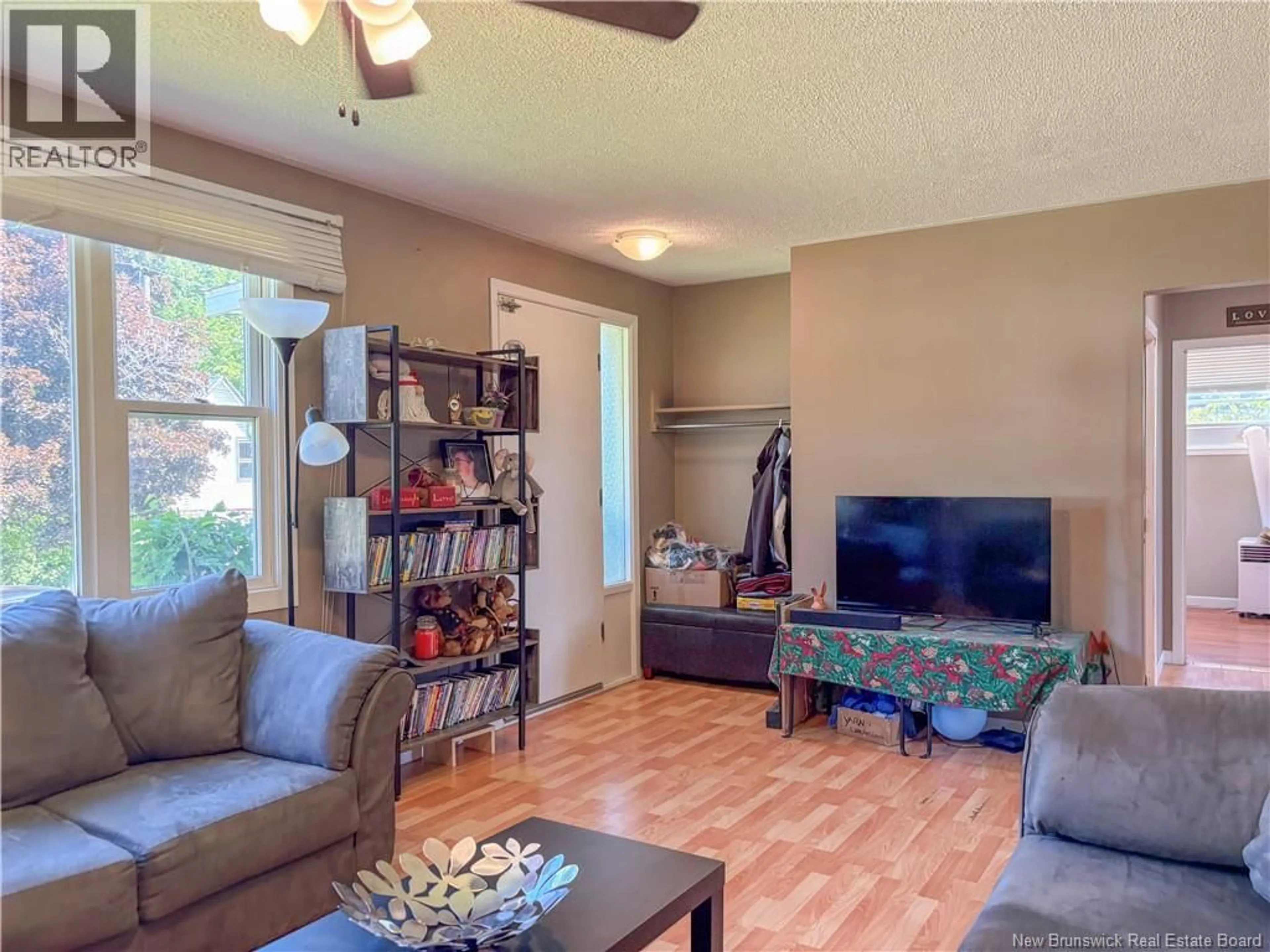 Living room with furniture, wood/laminate floor for 123 CAMBRIDGE STREET, Woodstock New Brunswick E7M1E1