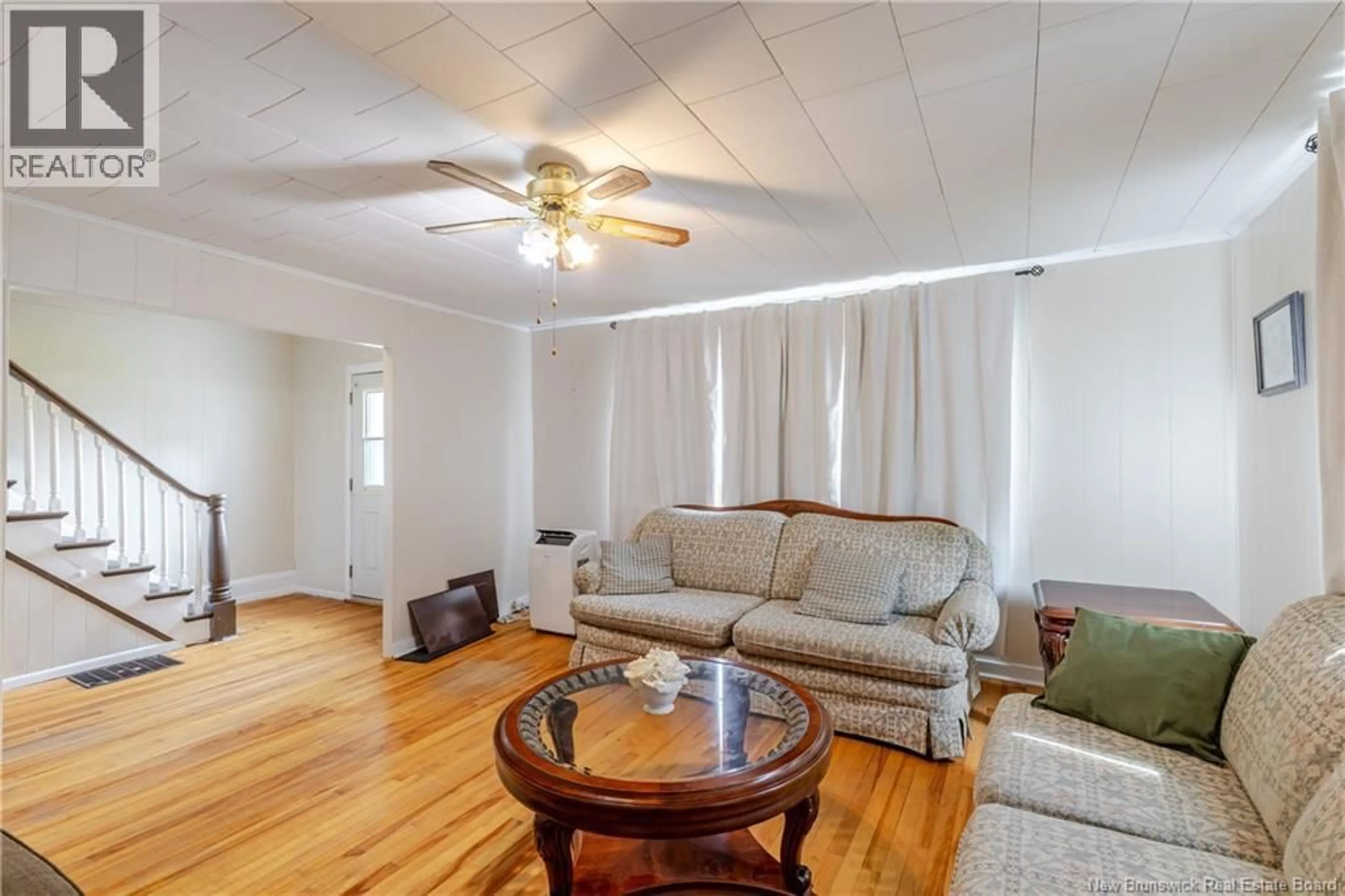 Living room with furniture, wood/laminate floor for 109 VICTORIA STREET, Woodstock New Brunswick E7M3A4